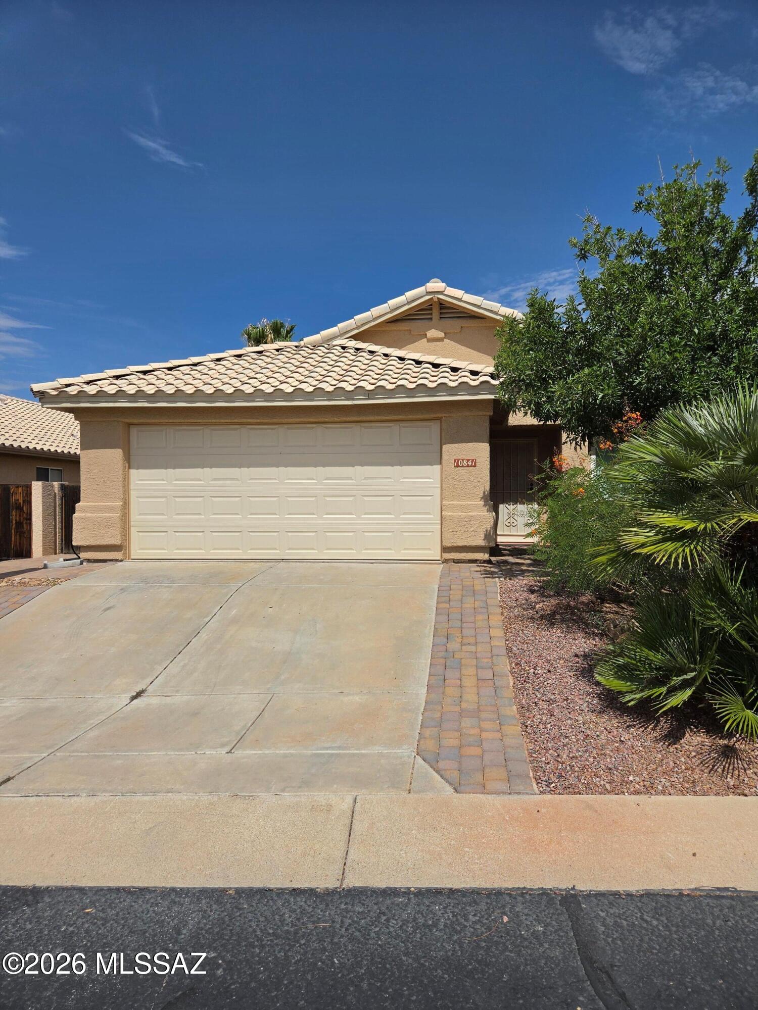 Welcome home to this beautifully updated 3-bedroom, 2-bath residence in the highly desirable Canada Hills community of Oro Valley. Thoughtfully refreshed with numerous upgrades, this move-in-ready home combines modern comfort with timeless appeal. Step inside to discover fresh interior paint, new carpet in all three bedrooms, and an inviting great room featuring a cozy gas fireplace. The spacious kitchen offers elegant granite countertops, a convenient breakfast bar, and a sunny breakfast nook. The primary suite has been enhanced with a brand-new vanity, while both bathrooms feature granite countertops. Additional updates include new PEX plumbing, a new HVAC system and water heater, new dual-pane energy-efficient windows, exterior paint completed in 2022, and a new washer and dryer. Sliding glass door leads out to a covered patio overlooking the low-maintenance backyard, complete with mature trees and established desert landscaping--an ideal setting for enjoying Arizona's beautiful weather. New front pavers add to the home's attractive curb appeal. This exceptional home offers the perfect blend of quality updates, comfortable living spaces, and a prime Oro Valley location close to parks, golf, shopping, dining, and top-rated schools. Don't miss this outstanding opportunity to make this beautifully updated home yours!