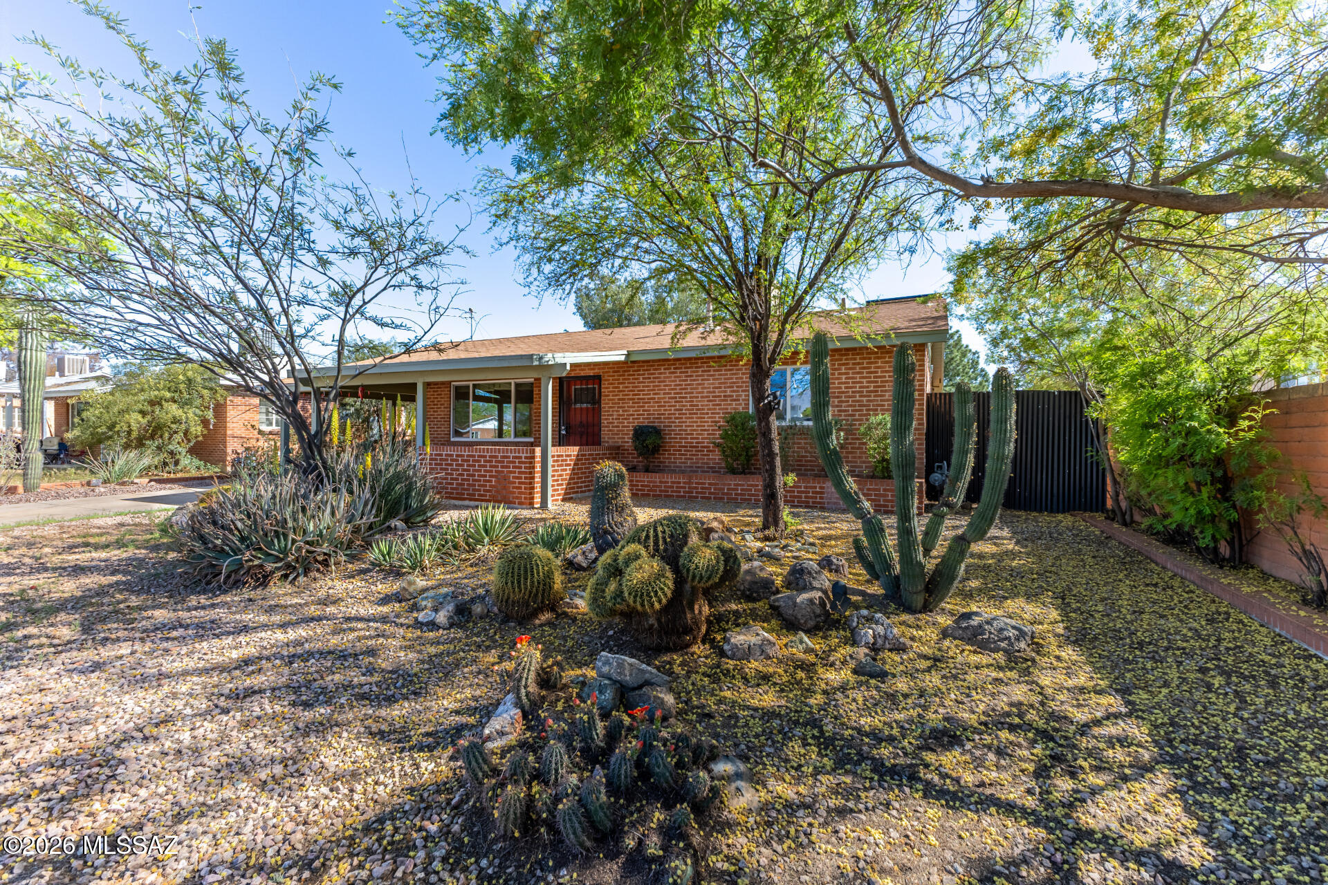 Charming midtown brick home offering flexibility, functionality, and income potential! This 3-bedroom, 2-bath main residence features a light and bright interior with wood-look flooring in the living areas, a soothing color palette, and a comfortable layout designed for everyday living. The kitchen includes white cabinetry, granite tile countertops, and a gas stove, along with a cozy nook for dining.

Situated on a spacious lot with north/south exposure, the property includes a covered patio, pavered entertaining areas, wood-fired oven, and mature landscaping, including Meyer lemon trees. A rolling gate with alley access provides additional parking and room for recreational vehicles or storage.

A standout feature is the detached ~488 sqft guest house/studio, offering exceptional versatility. The structure is currently unplumbed and does not include a kitchen or bathroom, but presents an opportunity for future improvement. Ideal for use as a studio, workshop, office, or additional flex space, with potential for conversion to next-gen living space or rental use.

Additional features include an OWNED solar system for energy savings, Low-E windows, and a combination of evap cooling and central AC.

Conveniently located near shopping, dining, and everyday amenities, this property offers a unique opportunity for buyers seeking flexible living space with future income potential.