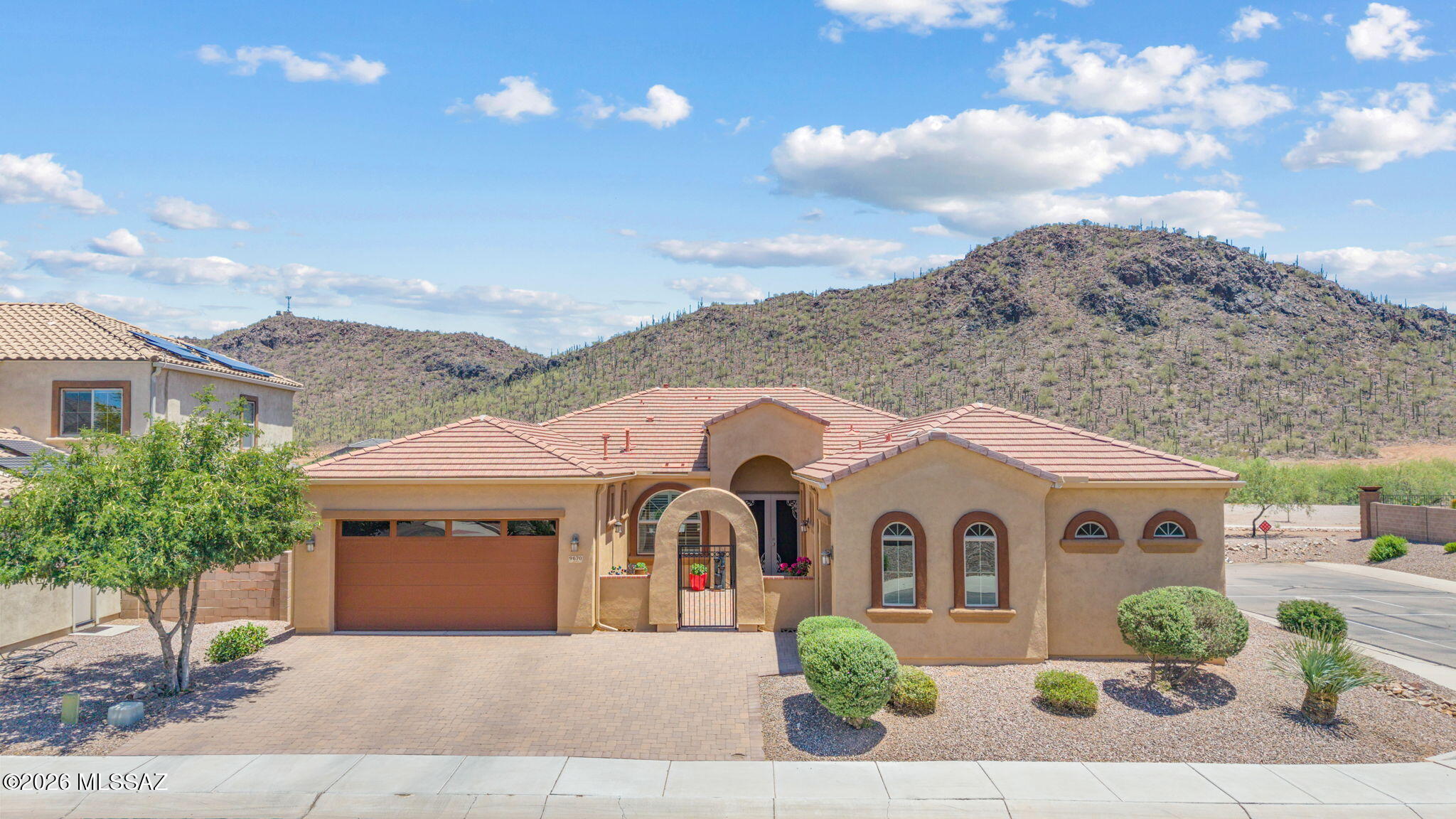Move-in ready contemporary home with breathtaking mountain views on a premium private lot! This 4 bedroom, 3.5 bath home with den offers 3,009 sq ft of thoughtfully designed living space and a 3-car garage. Enjoy added privacy with no rear neighbors. The open-concept layout features granite countertops, rich cabinetry, stainless steel appliances, spacious living areas, and abundant natural light throughout. The oversized primary suite provides a relaxing retreat, while the paver courtyard and covered backyard patio create ideal outdoor living spaces to enjoy the surrounding desert scenery. Located in the Saguaro Bloom community with pools, splash pad, fitness center, walking paths, weekly food truck events, and quick access to shopping, dining, and everyday conveniences.