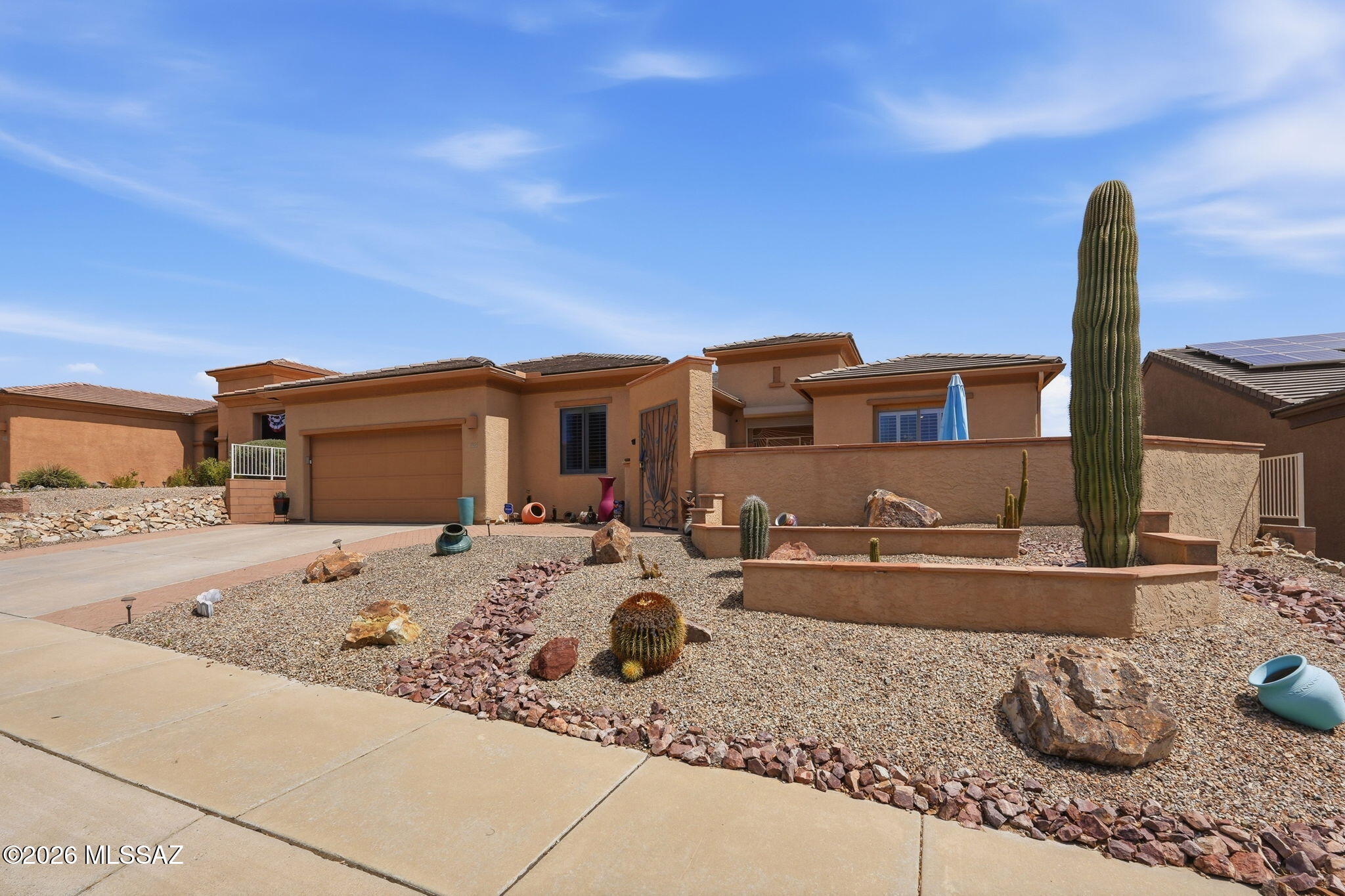 Luxury retirement living at its finest, w/options! Consider the possibilities of having a lock-off Casita in your home-ideal for hosting family & friends or sought-after rental. Santa Rita Mtn Views from gated Front courtyard invite you through the security entrance to this 2,765 sq ft home w/numerous upgrades & improvements inc. an expanded kitchen w/lg island, pantry, ample countertops & cabinets w/pull outs, enclosed AZ Rm, primary suite w/custom bathroom w/lg walk-in shower & closet w/washer/dryer. Expanded covered bk patio w/flagstone in landscaped backyard.  1,000 sq ft custom lock-off Casita w/kitchen, W/D, dining & living rooms. Extended 2-car garage w/storage. Re-roofed in 2025. 3 zone HVAC. Roller shutters, gutters, Sentricon termite system. See list of Furniture avail via SBOS!