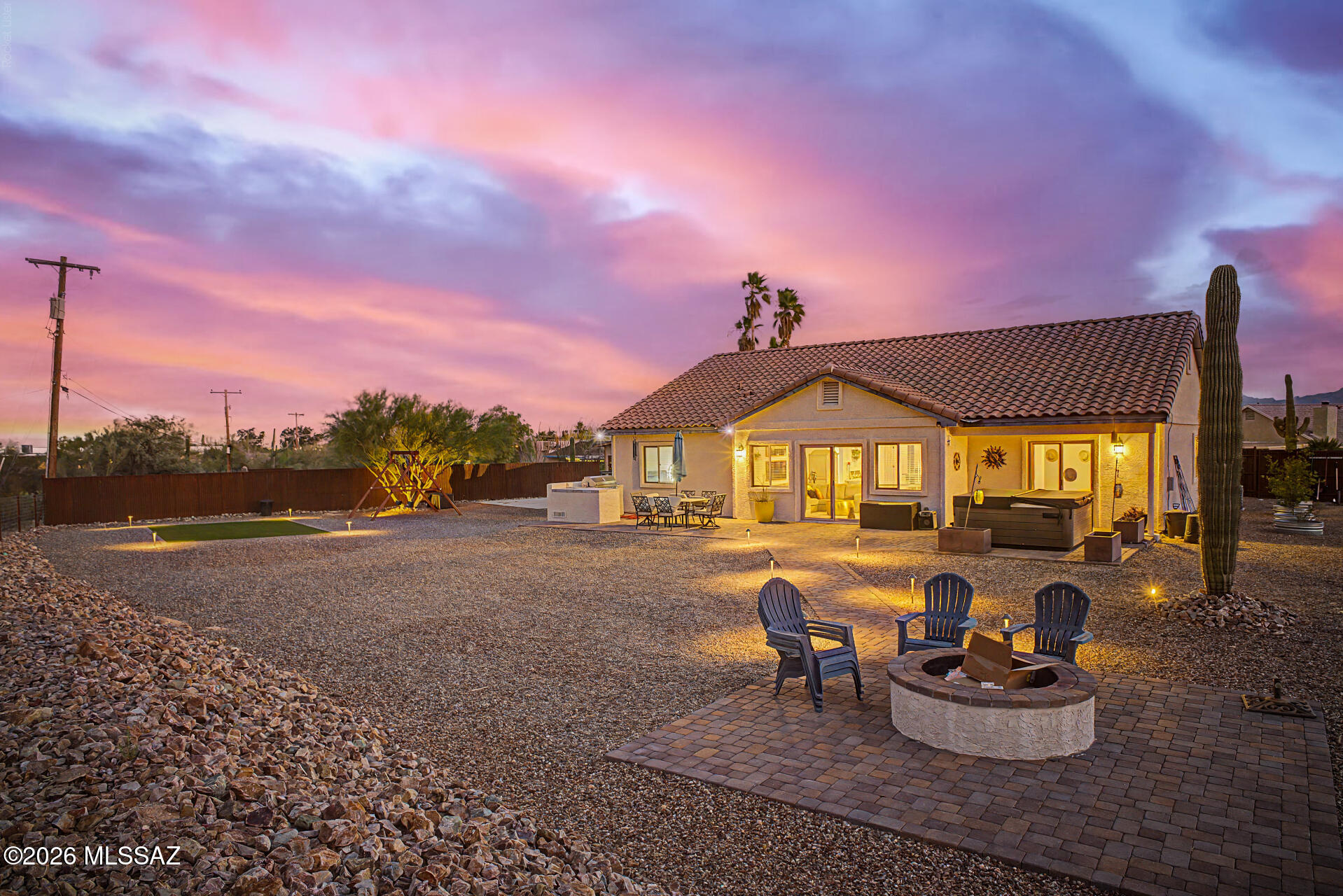 Seller will consider offers between $630,000-$650,000. Home, sweet home! Nestled on a spacious lot with sweeping Catalina and Tucson Mountain views, this home offers room for RV parking, outdoor living AND future expansion while providing a peaceful, private setting! The front paver patio welcomes you inside to a bright interior featuring a foyer, vaulted ceilings, neutral tones, wood-look tile, and carpet in all the right places. This home is perfect for everyday living and entertaining! The kitchen features SS appliances, granite counters, tile backsplash, recessed lighting, staggered cabinetry w/ crown molding, and a two-tier breakfast bar. Enjoy a low-maintenance backyard w/ a spa, built in grill, turf and concrete area and endless potential to customize! Make this gem yours TODAY! The primary offers private backyard access for comfort and convenience. The 4th bedroom, with a double-door entry & bay window, provides versatility. Relax or have a fun BBQ in the expansive backyard while enjoying tranquil mountain views! A hot tub, fire pit, and well-laid pavers for multiple seating areas complete the picture for serene mornings and lounging at sunset. This is a true gem!