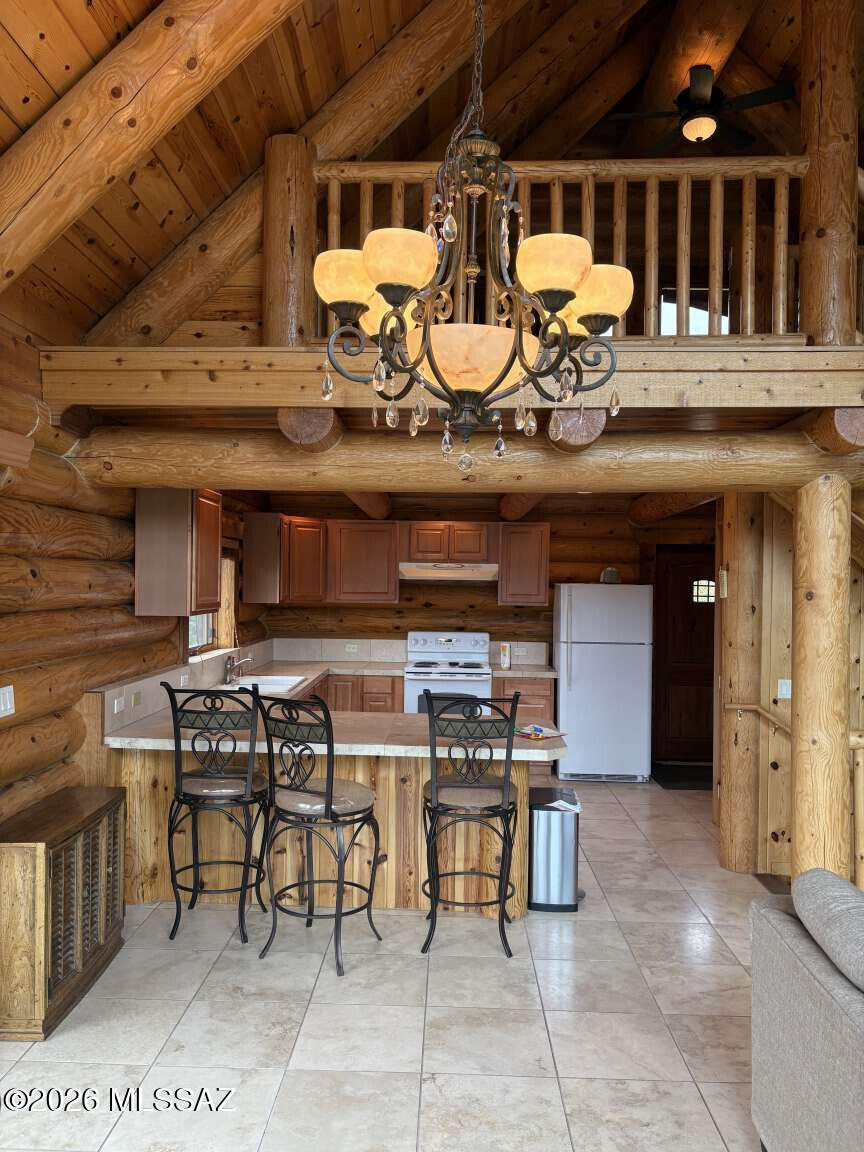 Well maintained gorgeous log cabin built in 2006 with metal roof. Beautiful mountain views with wrap around deck. One bedroom loft and one bath. Spacious living room area with wood burning fireplace. Large eat in kitchen with counter top seating. Ample space for a large dinning table. Tile floor. Large finished basement with pellet stove heating and washer and dryer hookups. Plumbing for an additional bathroom in the basement exists. There are lots of possibilities for the recently finished basement. Brick pavers provide parking for two vehicles. Year around accessibility with paved streets to the cabin.