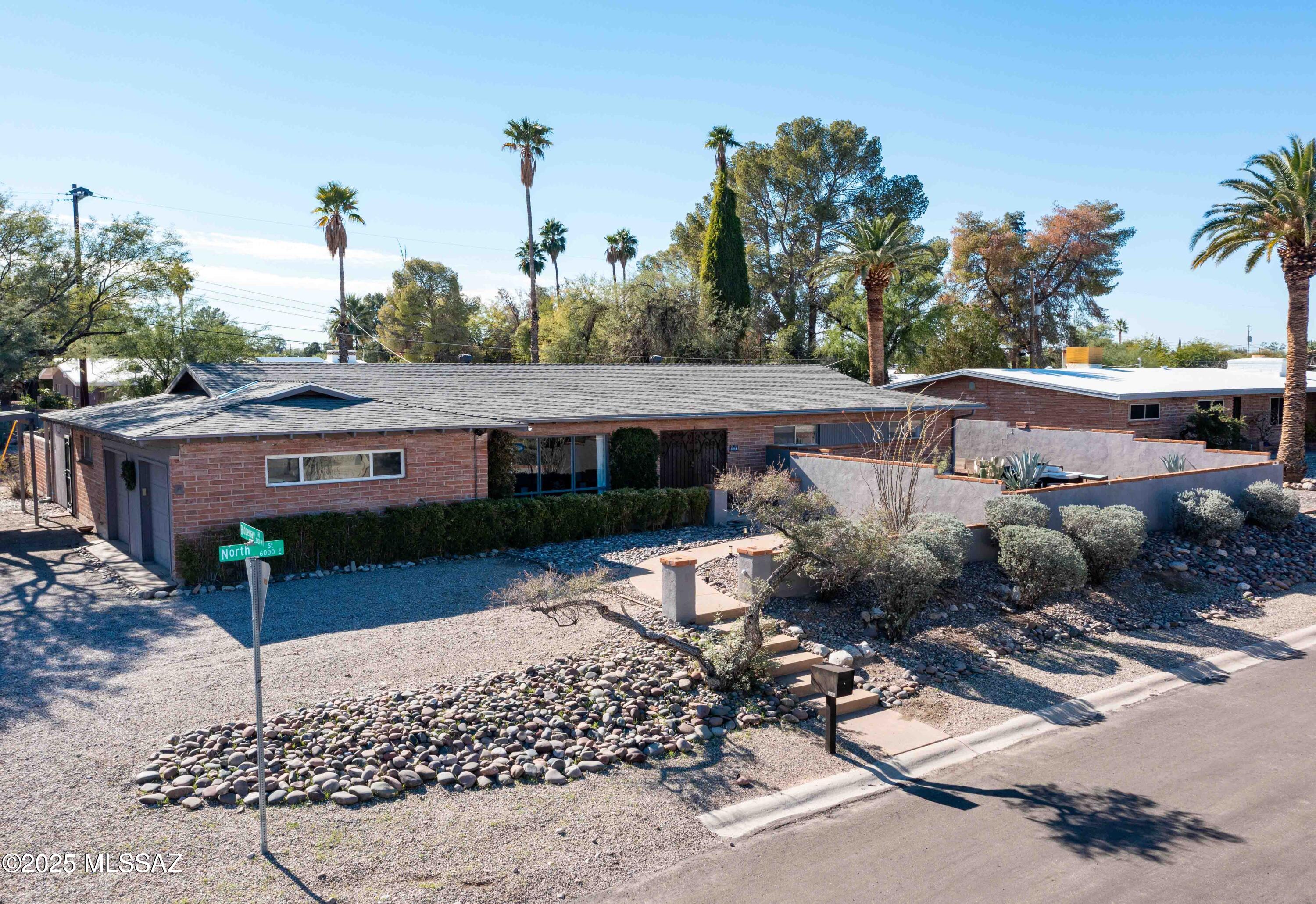 A beautifully remodeled Mid-Century Modern home is waiting for you in Rose Hill Estates.  This updated burnt adobe home sits on a corner lot and is move in ready.  Luxury vinyl can be found throughout a spacious floorplan that offers privacy or lots of room to entertain.  The Office/Bonus room offers many possibilities and has a private entrance. No worries with a newer HVAC system (2024) and roof (2023).  Take a step outside through the family room or the Primary Bedroom to enjoy the pool/jacuzzi or relax under the cabana.   Don't miss the north facing front yard that gives you a view of the Catalina Mountains.  This home is in close proximity to just about any amenity you could want.  Be sure to check out the interactive floor plan link and come visit today.