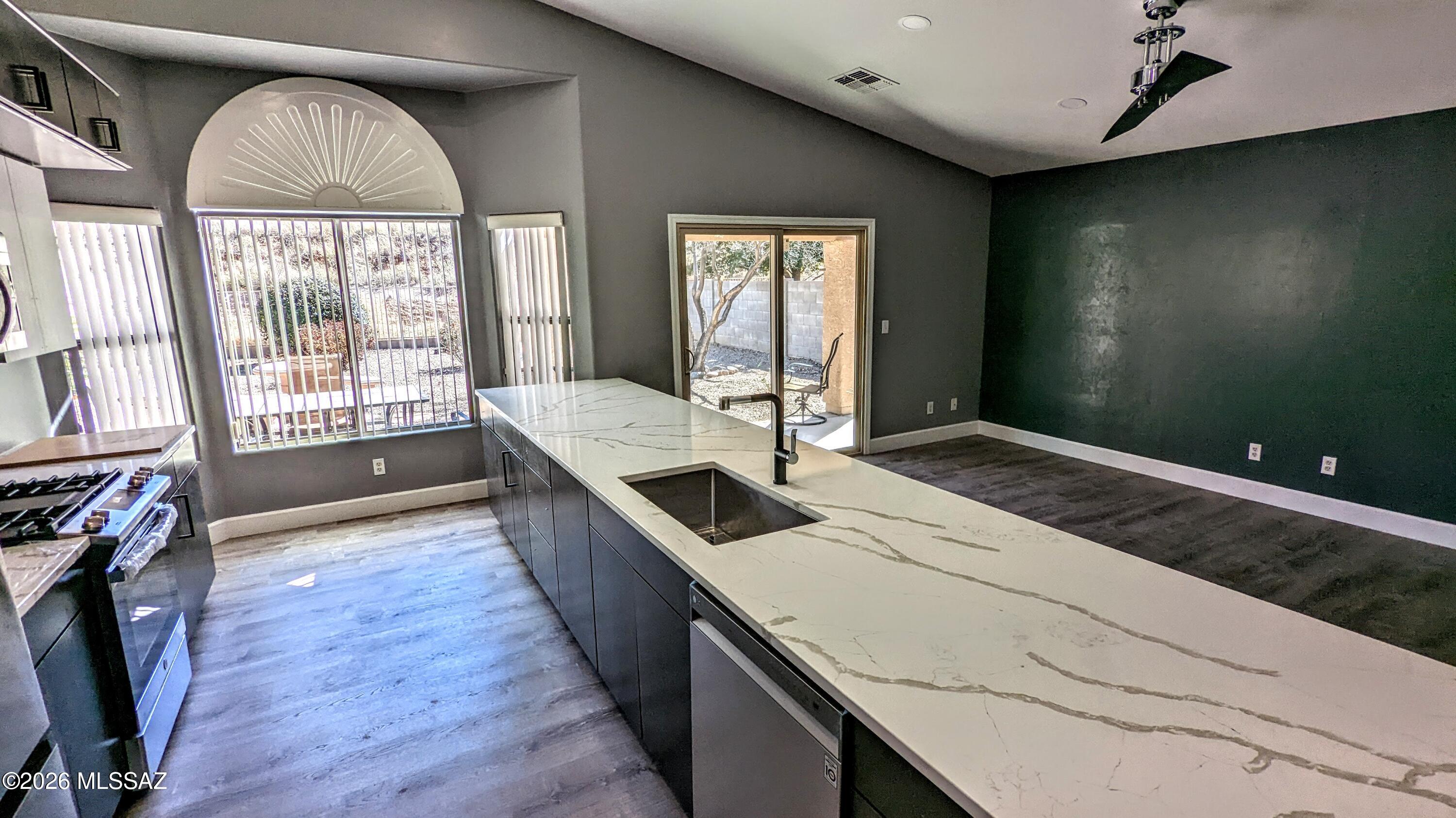 TOTALLY REMODELED AND UPDATED HOME! Stunning design, Gourmet Kitchen built for Entertaining with HUGE wall of Cabinets, NEW STAINLESS APPLIANCES, Massive Granite Slab, Richly Painted throughout, NEW Flooring, NEW Washer and Dryer, LED Custom Lighting, Gutted and Redesigned Bathrooms, Bay Windows, PRIVATE Rear Yard backing to Desert Common area hillside, Citrus, and so much more- come live and love in this Very Special home! WE DO FLEXIBLE LEASES! Call today for your Personal Tour!