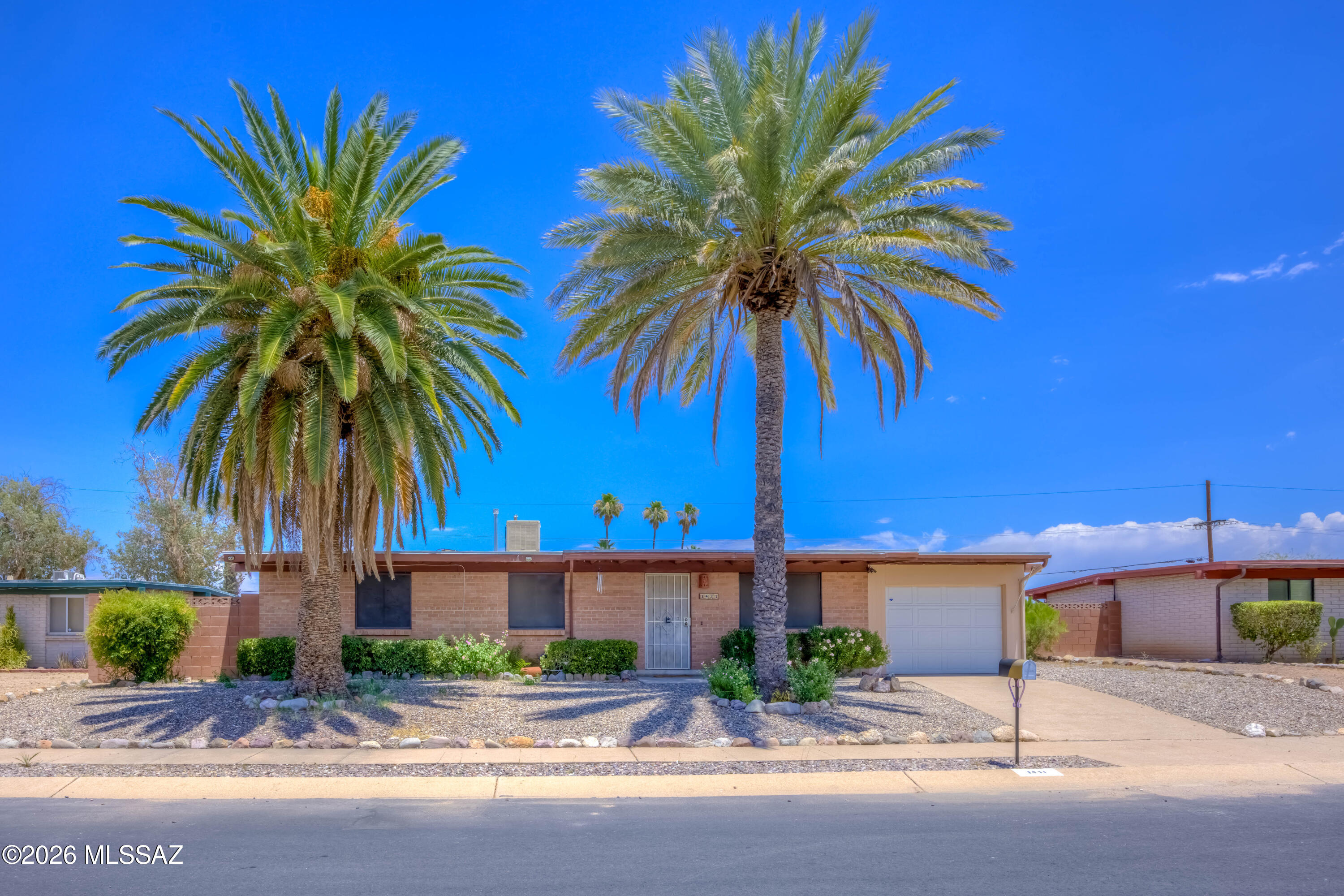 Move in ready 3BD/2BA brick ranch on Tucson's east side cul-de-sac. No HOA! Open layout connects living, dining & kitchen. Family room features a wood-burning fireplace & bar, perfect for entertaining. Primary suite with walk-in shower. Skylights & ceiling fans throughout. The Arizona Room overlooks the backyard with a spa, paver patios, lemon & orange trees, and stunning Catalina & Rincon Mountain views. Workshop and storage shed behind 1-car garage. RV gate with space available. Double-pane windows, wrought iron security door & low maintenance landscaping. Close to Rolling Hills Golf Club, The Loop, parks & shopping!