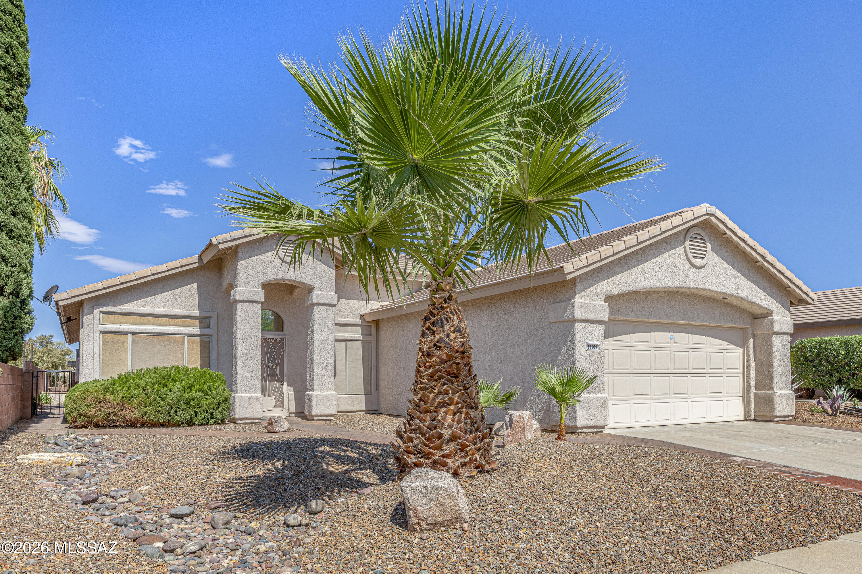 Enjoy the best of Oro Valley living in this lovely light-filled Canada Hills home that backs to a lush common area.  The greatroom features soaring vaulted ceilings, a cozy FP and opens to the kitchen with SS appl, island, built-in desk & abundant storage. Double doors lead to a spacious den, ideal for a home office or hobbies.  Unwind on the extended covered patio with pavers overlooking the gorgeous open desert behind. Generous primary suite with dual sinks, walk-in shower & soaking tub.   Large format neutral tile throughout. Large laundry room w/sink.  2-car garage w/built-in storage.  Newer HVAC & hot water heater. Just minutes from golf, Oro Valley Aquatic Center, shopping, dining, and the active lifestyle that makes Oro Valley so desirable.  New solar system for added efficiency.