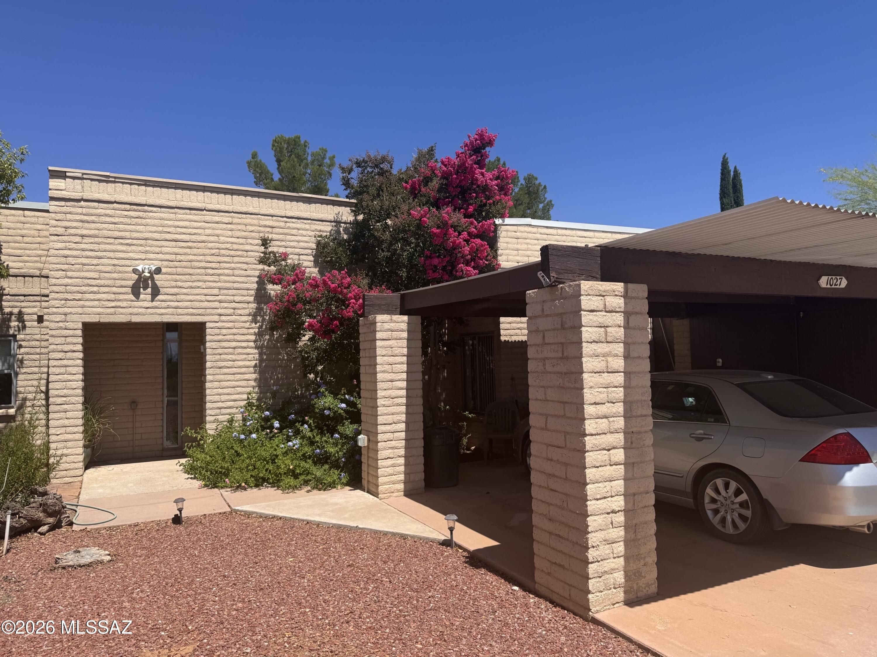 Beautifully updated and full of charm, this 1,637-squarae-foot townhome offers 3 bedrooms and 2 full baths and has been renovated from top to bottom with metal roof, user-friendly kitchen features granite countertops, roll-out shelving, and a large movable center island, perfect for meal preparation and entertaining. 
The spacious great room showcases rustic beam ceilings, a beehive fireplace, and original exposed brick that has been insulated and drywalled for added comfort and efficiency. Dual heat pump units provide separate climate control for each side of the home. Built-in cabinetry adds convenience in both the primary and secondary bedrooms. French doors from the primary suite open to a lovely Arizona room and flagstone patio, creating the perfect space to enjoy your morning coffee entertain guests, or simply relax while taking in the beautiful views. The enclosed backyard is ideal for small pets, and the home is fully handicap accessible, featuring wide hallways, doors, and a roll-in shower in the primary bath. Additional highlights include four parking spaces, two of which are covered.