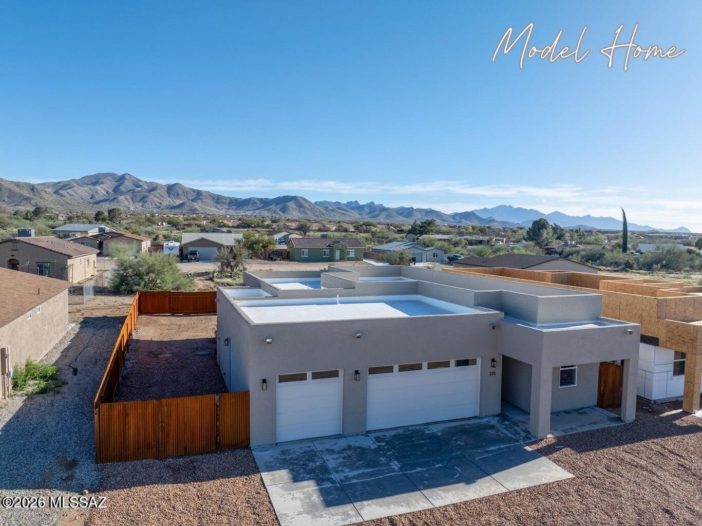 Look at the others and come here for quality and upgraded options! Contemporary Santa Fe style with 3 car garage, with added temp controlled storage room in garage and so many higher upgrades you'll be impressed!  Kitchen is fully equipped with stainless steel appliances suite, an oversized island with seating and spacious pantry.  Wonderful laundry with additional storage and wash/fold area. Granite tops on all countertops.  Wood plank tile floors in all main living areas.  Wonderful Primary Suite with grand walk in shower and huge walk in custom fitted closet.  Spray foam insulation and 2x6 construction- solid and efficient.  Rustic metal fence with double gate on North side.  Agent /Owner. Front and Back covered patios, landscape rock in front and a PAVED street. We have additional lots that will begin construction shortly, so if you want to customize paint colors or have a special request ,it's possible!  NO HOA.