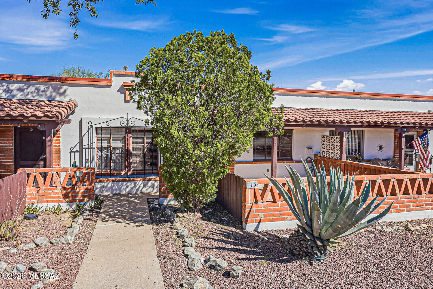 Experience the ease of low-maintenance living at Green Valley Villas East, where all major maintenance items are covered by the HOA -- giving you more time to enjoy everything this beautiful community has to offer. This unit includes a full-size washer and dryer -- no trips to the laundromat required. Inside, you'll also find a thoughtfully refreshed kitchen featuring updated cabinetry and full-size appliances, perfect for everyday cooking and entertaining. Authentic Saltillo tile flows throughout the home, lending a warm, true Southwest aesthetic that is both timeless and easy to maintain. Step outside and take advantage of both a covered front and rear patio, ideal for relaxing mornings, evening gatherings, or simply soaking in the outdoors year-round. The location couldn't be better -- just a short walk to the weekly farmers market, boutique shopping, and a variety of dining options, putting the best of the neighborhood right at your doorstep.