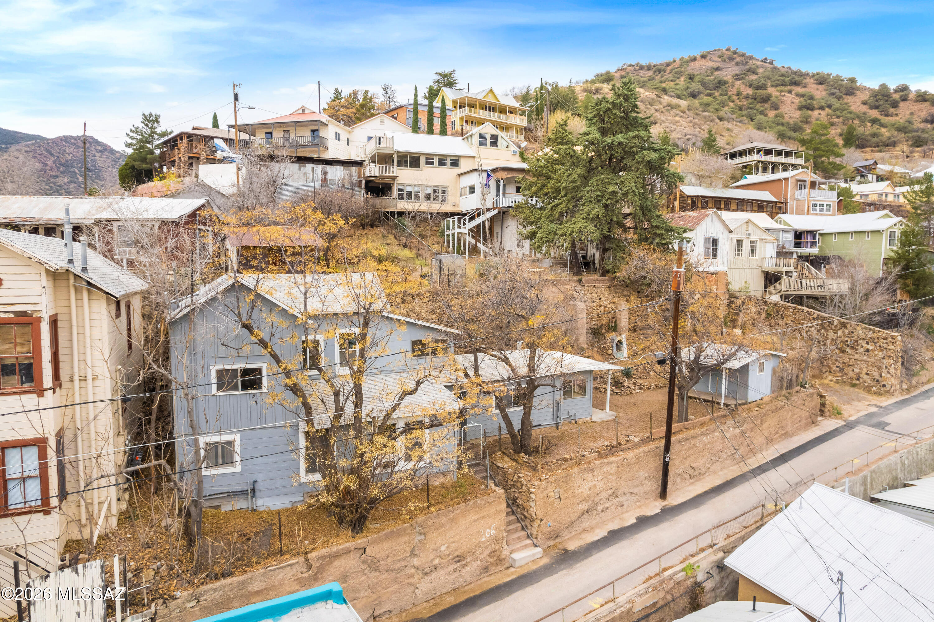 Move-In Ready Home in the Heart of Old Bisbee. Discover this beautifully maintained 1,723 sq. ft. residence nestled in the highly desirable Old Bisbee neighborhood. This charming three-bedroom, two-bathroom home seamlessly blends character with modern comfort, offering an inviting and functional layout ideal for full-time living or a retreat-style lifestyle. The home features a gas stove, air conditioning, and thoughtful upgrades throughout, ensuring year-round comfort. A detached workshop/studio provides exceptional flexibility—perfect for an artist's studio, home office, or creative workspace. Convenient public parking nearby adds to the ease of everyday living in this historic setting.