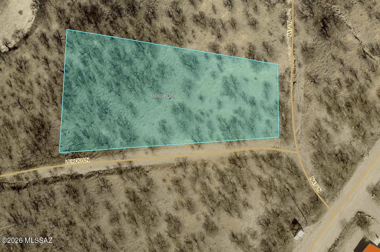 Vacant land opportunity in Rio Rico Ranchettes Unit 5. Approx. 0.87-acre parcel with frontage on Nat Ln and Lerdo Ln and convenient access from paved Mulberry Corte nearby. Electric and water are available in the area along Mulberry Corte (buyer to verify connection costs and exact locations). Septic required. Great spot for a future homesite or weekend getaway with wide-open desert views.