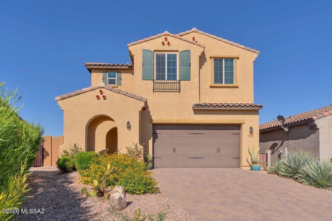 Seller will consider all reasonable offers. Situated within the sought after gated community of Center Pointe at Vistoso, this stunning home is move-in ready and has been thoughtfully transformed since its 2017 construction. With more than $125K in upgrades, the home delivers luxury finishes, a heated pool, and a fully owned solar system throughout. The main level is designed for open living, anchored by a chef's kitchen appointed with two-tone soft-close cabinetry that extends to the ceiling, quartz countertops, a glass tile backsplash, and stainless appliances. The great room features a 48-inch stone-clad linear gas fireplace finished with a hand-crafted wood mantle as its focal point. A custom wrought iron staircase railing paired with solid wood treads leads to the upper level. The primary suite enjoys stunning Mountain views and offers a spa-inspired bath complete with a soaking tub and an oversized glass shower. Step outside to a resort-caliber backyard framed by silver travertine decking. The private heated pool features a calming fountain with views of the Catalina Mountains, while a fully equipped outdoor kitchen overlooks the Tortolita Mountains- an entertainer's dream in every season. Just steps from the community center, residents enjoy a 25- meter pool, hot tub, splash pad, BBQ grill with seating, a lounge with fireplace, and an outdoor kitchenette. Beyond that, a playground, ramadas with picnic tables, walking paths, and direct access to the 6.2- mile paved Vistoso Trail round out the amenities. The surrounding area offers an outstanding bike lane connecting to the 135-mile Loop multi-use path, schools, parks and a nearby plaza with a grocery store and shops. Oro Valley Hospital within 10 minutes, along with world-class hiking at Catalina State Park, 20+ miles of mountain biking at Big Wash Trailhead, and the Oro Valley Marketplace with dining, retail, and fitness studios.