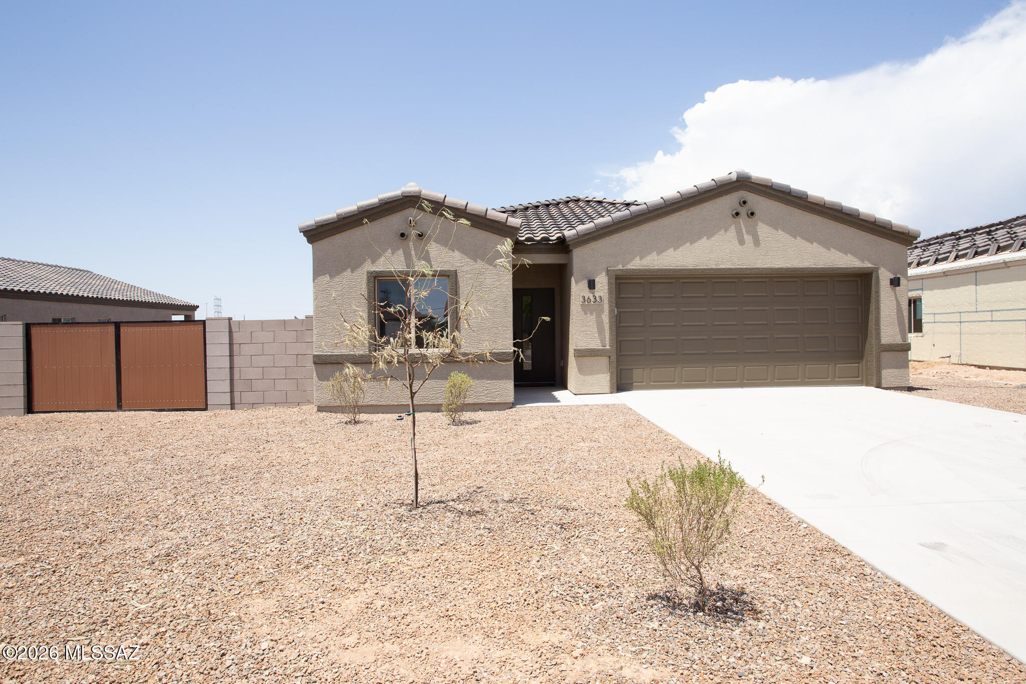 Beautiful Brand-New Modern Home that offers a spacious & inviting floor plan on LARGE LOT with modern finishes, tile flooring throughout & NO HOA! Enjoy the spacious backyard w/full length covered patio, great for entertaining, enough space to add a pool, & w/10 ft double side gate. Our last QUICK MOVE IN READY! Easy access to I-10 & the ''The Loop'', a system of paved paths perfect for walking, running & biking. Plus, the home is located on a lighted street recently repaved. The beautiful interior & thoughtful design includes kitchen w/island, 42'' upper cabinets, quartz countertops, backsplash, modern window blinds, stainless-steel appliances & sleek matte black fixtures offering a perfect blend of modern elegance & appeal. High ceilings. Modern primary bathroom featuring 12x24 Italian porcelain tile shower surround tiled from floor to ceiling, glass shower door, 10-inch raincan showerhead, double square undermount sinks, quartz countertops, medicine cabinet, barn door & walk in closet. Backyard with mountain views, decorative rock and large covered patio. Built for Efficiency & Comfort: 2x6 exterior walls (33% thicker than standard construction) for enhanced durability and insulation. Soundproof insulation in interior walls for a quieter living experience. Advanced spray foam thermal shield for energy efficiency and year-round comfort. Smart thermostat & camera doorbell for modern convenience. Garage with Wi-Fi Enabled automatic door opener with 2 remotes and keypad for easy access. Prewired for 220-volt outlet in garage ready for electric vehicle. Ceiling fans in bedrooms, great room and covered patio. LED lighting. Front yard landscaping with auto drip irrigation. Offering a 2-10 New Home Builder Warranty for peace of mind. The highly anticipated Mosaic Quarter sports & entertainment district is just 2.3 miles away, promising exciting future amenities. Call Agent for more details & incentives. Don't miss the chance to own this beautiful new home!