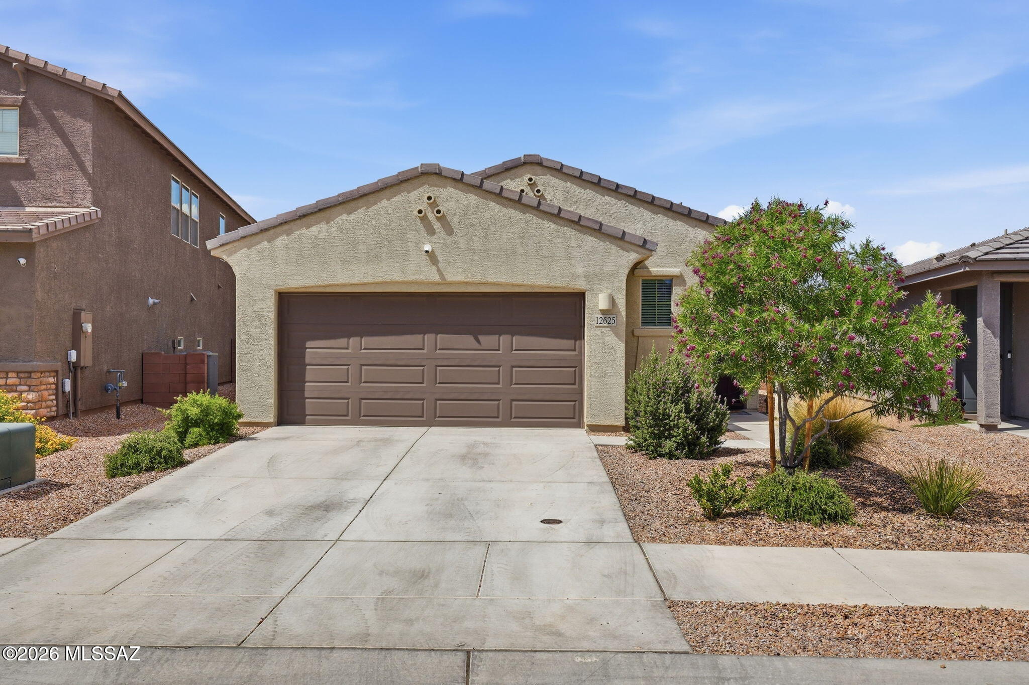 Move-in ready and energy efficient, this single-story Hanson Ridge home offers 3 bedrooms, 2 baths, and an open-concept layout. The kitchen features granite countertops, stainless steel appliances, a walk-in pantry, and overlooks the dining and living areas, creating a functional space for everyday living and entertaining. Tile flooring runs throughout the main living areas, and the split-bedroom floor plan provides separation between the primary suite and secondary bedrooms. Enjoy the covered patio, extended paver patio, and low-maintenance turf yard with no rear neighbors and Rincon Mountain views. Located in Hanson Ridge within the highly rated Vail School District, with convenient access to I-10, shopping, dining, and major employment centers