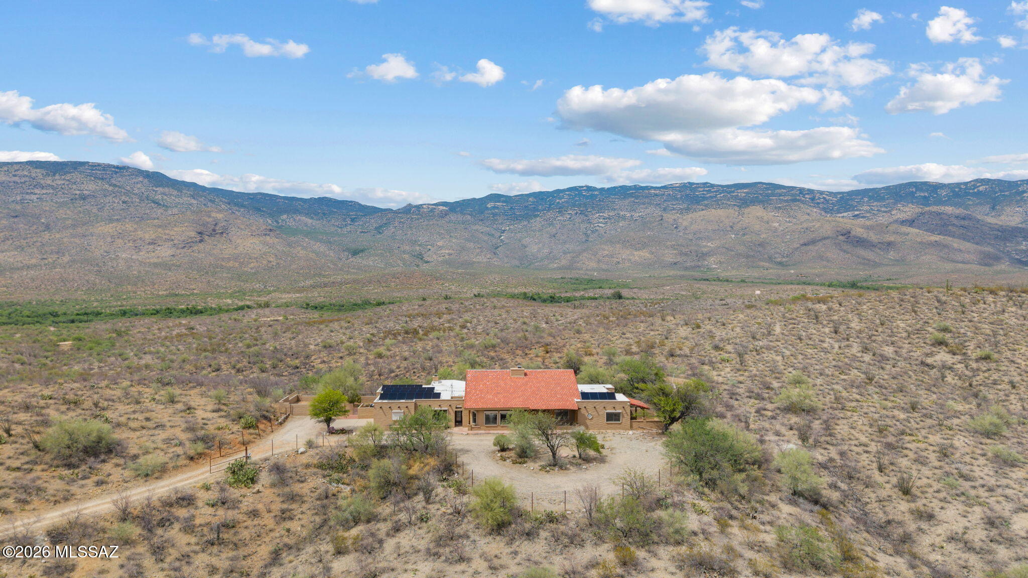 Hilltop ranch home set on 36 secluded acres of lush high desert, in gated X9 Ranch, overlooking the Rincon Valley. Sunken gameroom with a cantina, dual rock fireplace and TV in Living Rm & an interior wine cellar. 5 Bedrooms/3 full baths. Primary suite includes a big screen TV and Sunroom. Luxurious ensuite jetted tub & full shower. Guest Bedroom 2 has a private patio; Guest Bedroom 3 has a cozy loft; Bookshelves, exterior door and window seat in Bedroom 4 (Office);  an indoor sauna and a mirrored wall in Bedroom 5(Fitness Rm). Mountain views from plenty of windows and skylights. Niches, custom architectural details and tilework give it a true ranch feel. Mexican tile flooring throughout. Owned solar. Covered patio, elevated spa patio, rainwater cistern. Gourmet Kitchen. Newer appliances. Some wood beams came from Mt Lemmon! Private well, Septic, Propane (for spa only). New Rhinoshield exterior paint on house and backyard walls (25 yr warranty). 2 A/C units were replaced 2025. Roof was sealed & recoated Oct 2024. Rainwater collection tank on Bedroom 5 patio. New water softener. Updated central vacuum system. Newer washer & dryer. Fireplaces both serviced and capped properly. Newer spa sand filter, variable speed pump & heater. Close to Saguaro National Park, Colossal Cave, hiking, AZ Trail. Award winning Vail Schools. 18 minutes to grocery, pharmacy, shopping, gas, and restaurants.