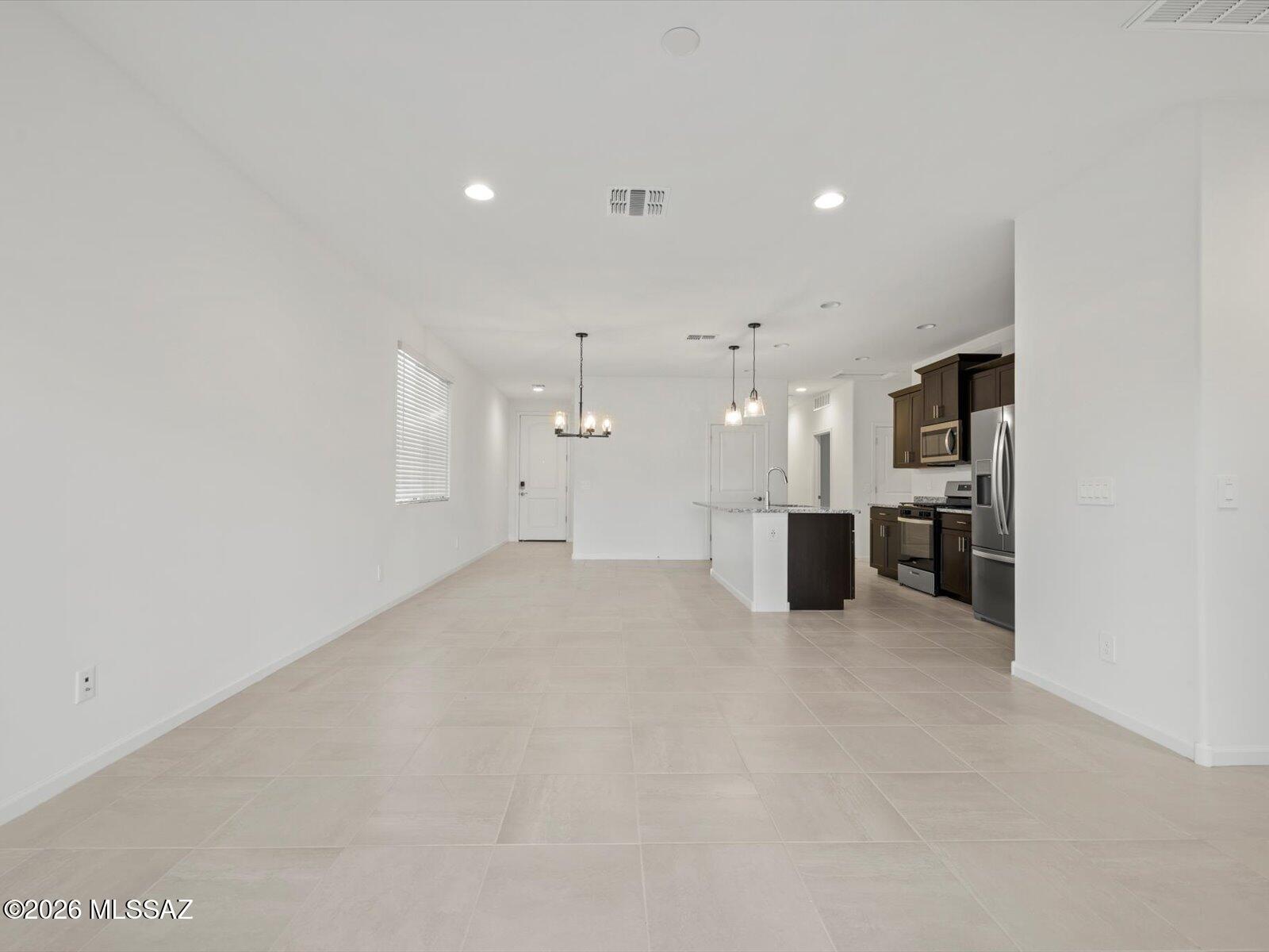 Move-In Ready in Mandarina! This beautifully designed single-story home offers 3 bedrooms, 2 bathrooms, and a 2-car garage with an open-concept layout perfect for entertaining. The spacious great room flows seamlessly into the kitchen, creating the ideal space for gathering with family and friends. Escape to the private primary suite, thoughtfully tucked away for added relaxation and comfort. Located in the sought-after Mandarina master-planned community in Marana, residents will enjoy incredible amenities including a resort-style pool, pickleball courts, playgrounds, a dog park, and more. Plus, this home is move-in ready with a washer, dryer, refrigerator, and whole-home blinds included. Built with innovative energy-efficient features for comfort, savings, and peace of mind.