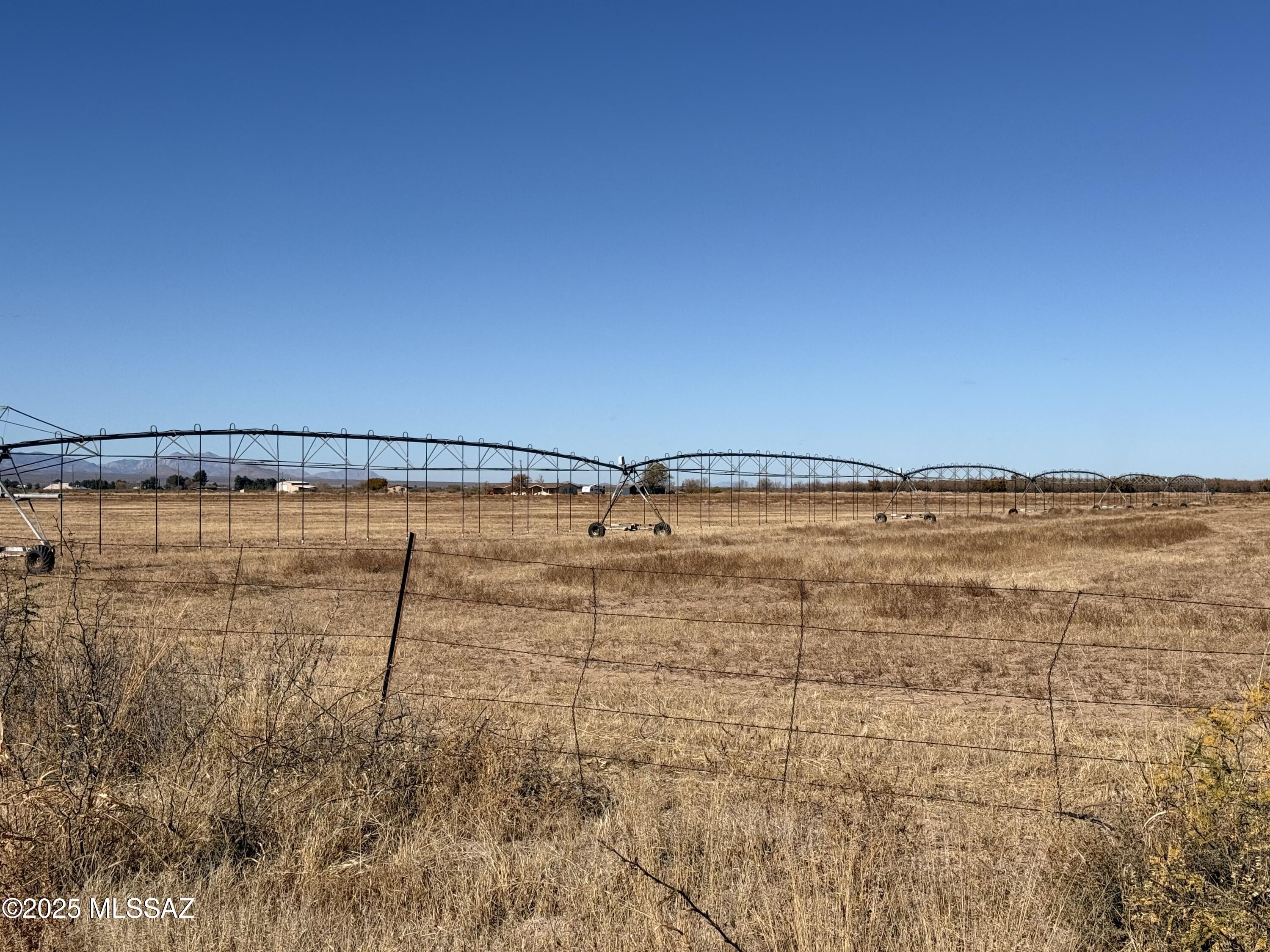 This 77± acre agricultural property offers an excellent opportunity for farming, ranching, or investment use. Located within the Douglas AMA, the property includes approximately 60 dedicated acres of water rights and is well positioned for agricultural production.
While the property has not yet been farmed by the current owners, it is fully set up and can easily be put into production. The land features mini pivot irrigation systems, designed for efficient water use. Currently in place are one full mini pivot and one half mini pivot. A ¾ mini pivot is also on the property and available to be built, providing additional flexibility and expansion potential. The farm includes three irrigation wells. One well is fully functional and ready for use and has been recently serviced with rebuilt and replaced components as needed, resulting in a system that functions like new. Improvements, repaired/new or replaced, include a Simflo pump, column pipe, tube and shaft, along with a natural gas Cummins NG engine, producing approximately 400 GPM at a depth of approximately 650 feet. Two additional irrigation wells, each approximately 350 feet deep, are also located on the property and are not currently in use. *Buyer to verify future use of these 2 wells. 

 A rare opportunity to acquire acreage with significant water resources, efficient irrigation infrastructure, and strong agricultural potential in Cochise County.