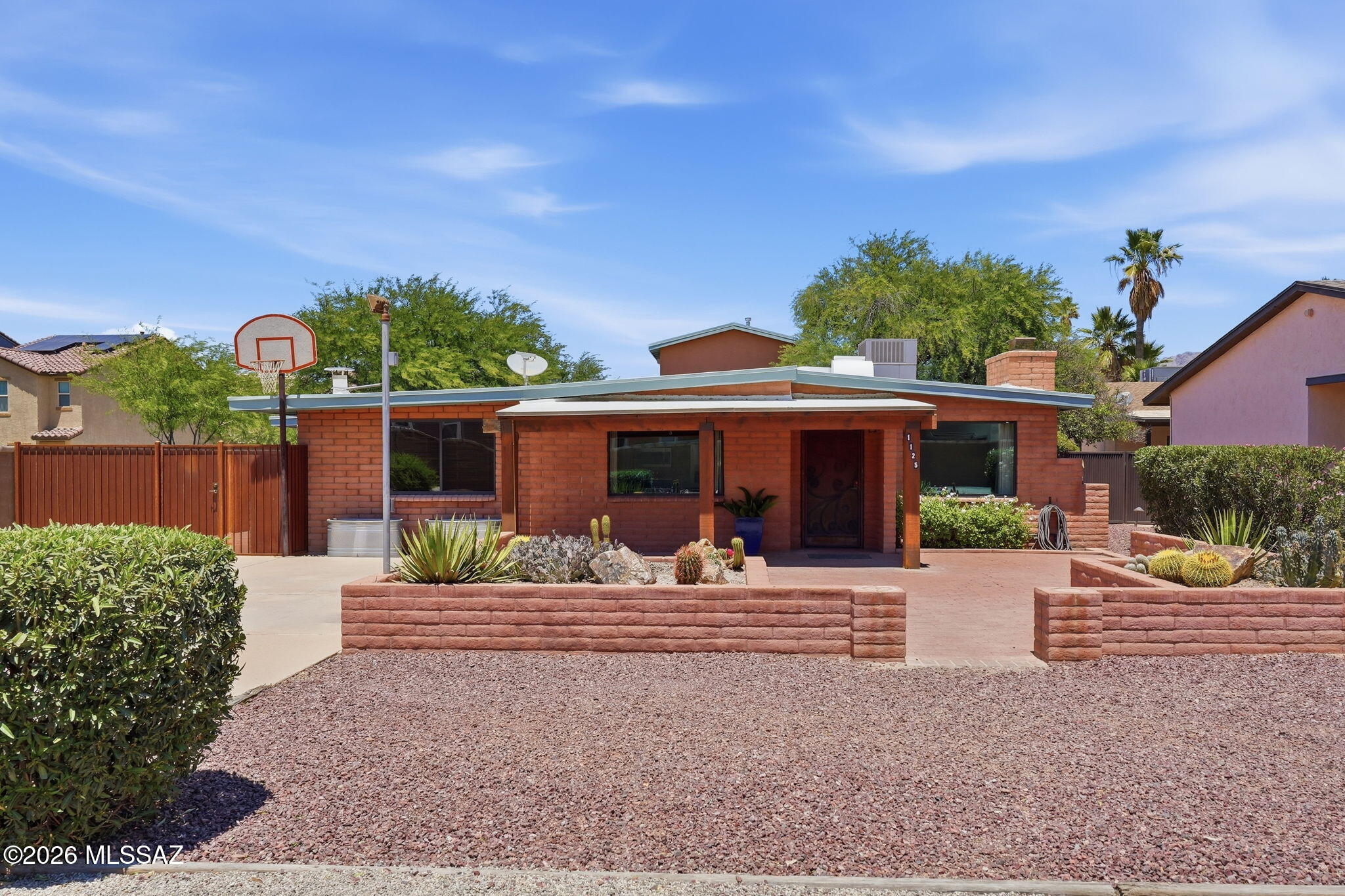 Two-home property near the University of Arizona with mature vegetation, lots of parking, and flexible living options! The front burnt adobe main house offers 3 bedrooms, 2 bathrooms, a great room with fireplace, a family room with wood-burning stove, and plenty of character throughout. 

The back house, built in 2005, features a full kitchen, metal roof, a downstairs bedroom and full bath, plus an upstairs loft bedroom with shower-only bath and walkout balcony. Rolling shutters on the guest house and security doors on all exterior doors add privacy and convenience. Could be a great multi generational living space, house hack where you rent one unit and live in the other or a short, mid or long term rental!