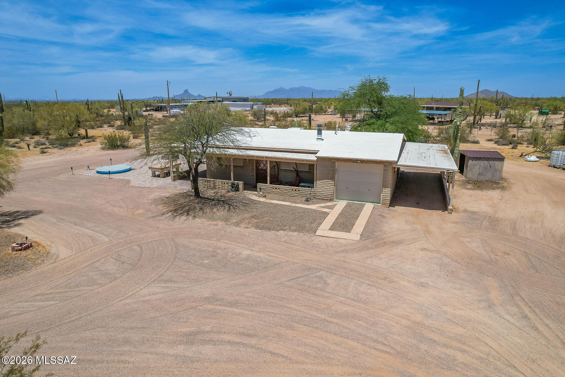 This Charming Ranch Style Home is nestled on 2.97 Acres (Horse property) and offers 2 Bedroom, 1 bath with Dining area, Family room, Garage and 2 Covered Carports all attached to the house. The Kitchen has a Stainless Steel Refrigerator, Microwave, Electric Range, Also a Refrigerator in the garage along with Washer & Dryer. A Nice Size Brick Paver Patio that contains a 9' Diameter Round Poly Stock Tank (Cowboy Pool). The Patio looks out to the natural desert landscape. This is A Great home for all looking for the Country Life and NO HOA.