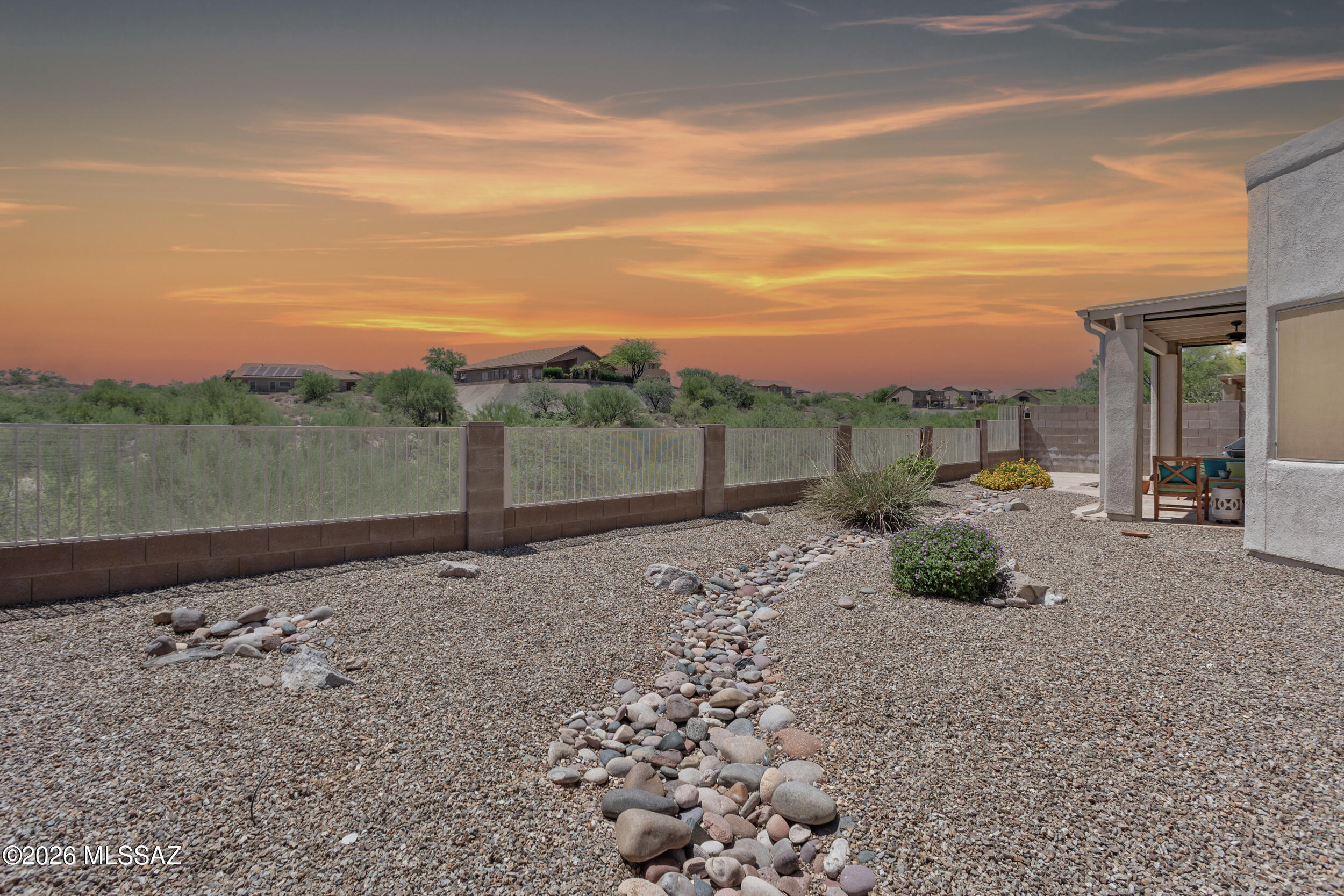 Capturing the best of desert living, this home is surrounded by views - from the breathtaking, and sunset filled backdrop of the natural desert to the stunning Catalina Mountains. Enter into a bright and airy home where sunlight fills the rooms, the color palette is neutral, plantation shutters are throughout and no carpet to be found. The open concept offers a spacious kitchen with plenty of counter & cabinet space, pantry and island that flows into the great room. Nearly every window offers a mountain or desert view. There are many thoughtful additions to this home including electronic sunshades that transform the covered patio into an enclosed retreat, reverse osmosis systems in the kitchen and primary bathroom, seasonal solar and standard shades for each window, newer roof and more.