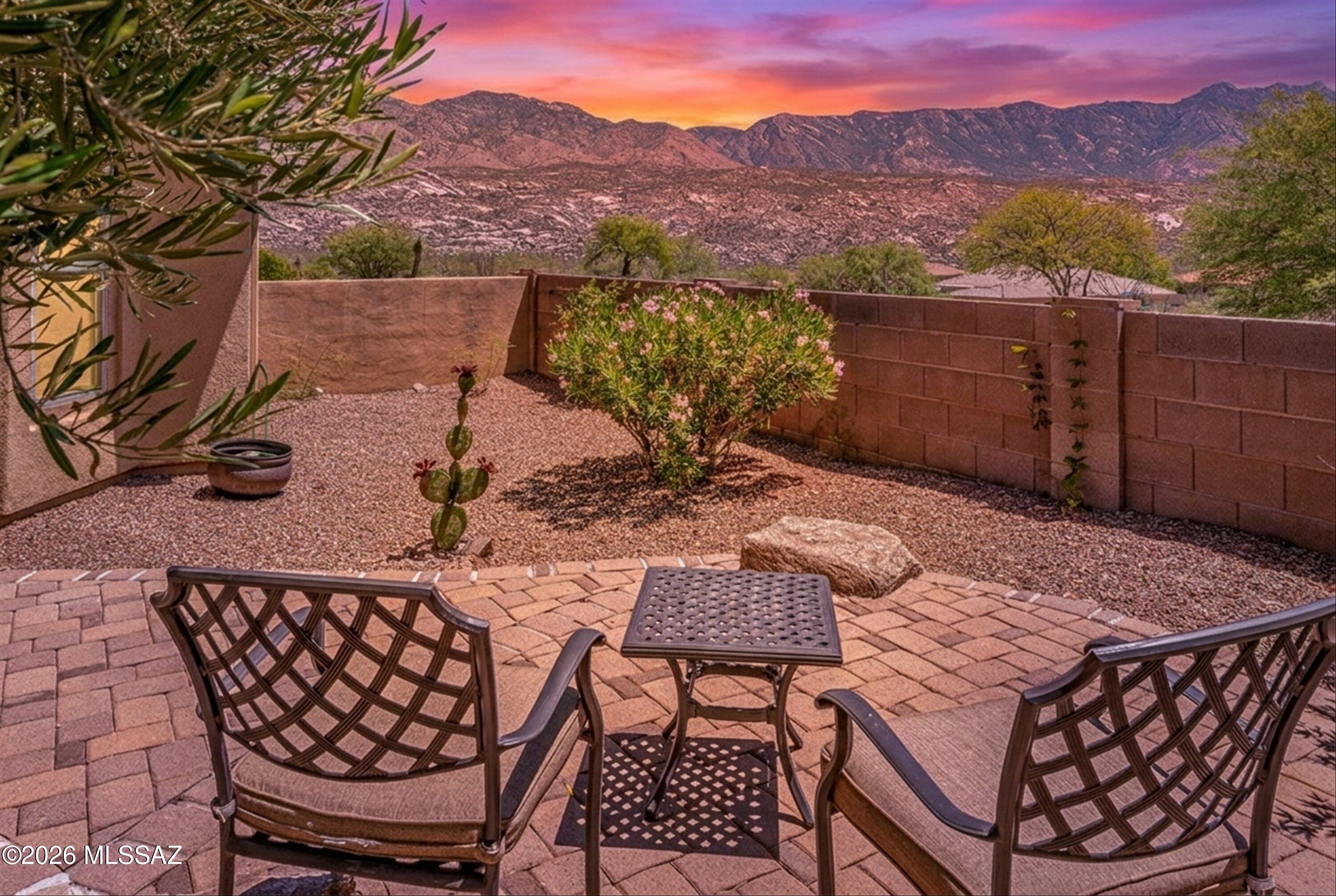 The welcoming courtyard opens into a stunning Sabino model with a private guest Casita. Located on a prime lot, this SaddleBrooke Preserve residence exemplifies the finest SaddleBrooke living for both you and your visitors. As you enter, warm engineered wood floors guide you toward a expansive great room, which overlooks the inviting Arizona Room and open space beyond. This area is perfect for hosting gatherings or relaxing by the gas fireplace framed in stacked stone. The dining section of the great room easily accommodates large dinner parties.
A generous island kitchen offers ample cabinetry and counter space, complemented by stainless appliances including a built-in refrigerator and gas stove. The bright breakfast nook provides a view of the entry courtyard. The primary suite boasts a bay window creating an inviting spot to observe local wildlife go by. Its en-suite bathroom features a walk-in tile shower, double vanities, a large soaking tub, and a walk-in closet. Guests enjoy privacy with their own suite and en-suite bath. The functional den/office features built-in cabinetry and ample storage options. Additionally, the property offers a three-car garage and a laundry room with generous storage capacity, enhancing the overall convenience of this exceptional home.
The Arizona Room serves as an excellent venue for entertaining or simply embracing the SaddleBrooke lifestyle. Outdoors, a hidden gem awaits: a paver pathway leads to a patio presenting an exceptional, unobstructed mountain view. Take this opportunity to experience SaddleBrooke at its best in this exceptional home.