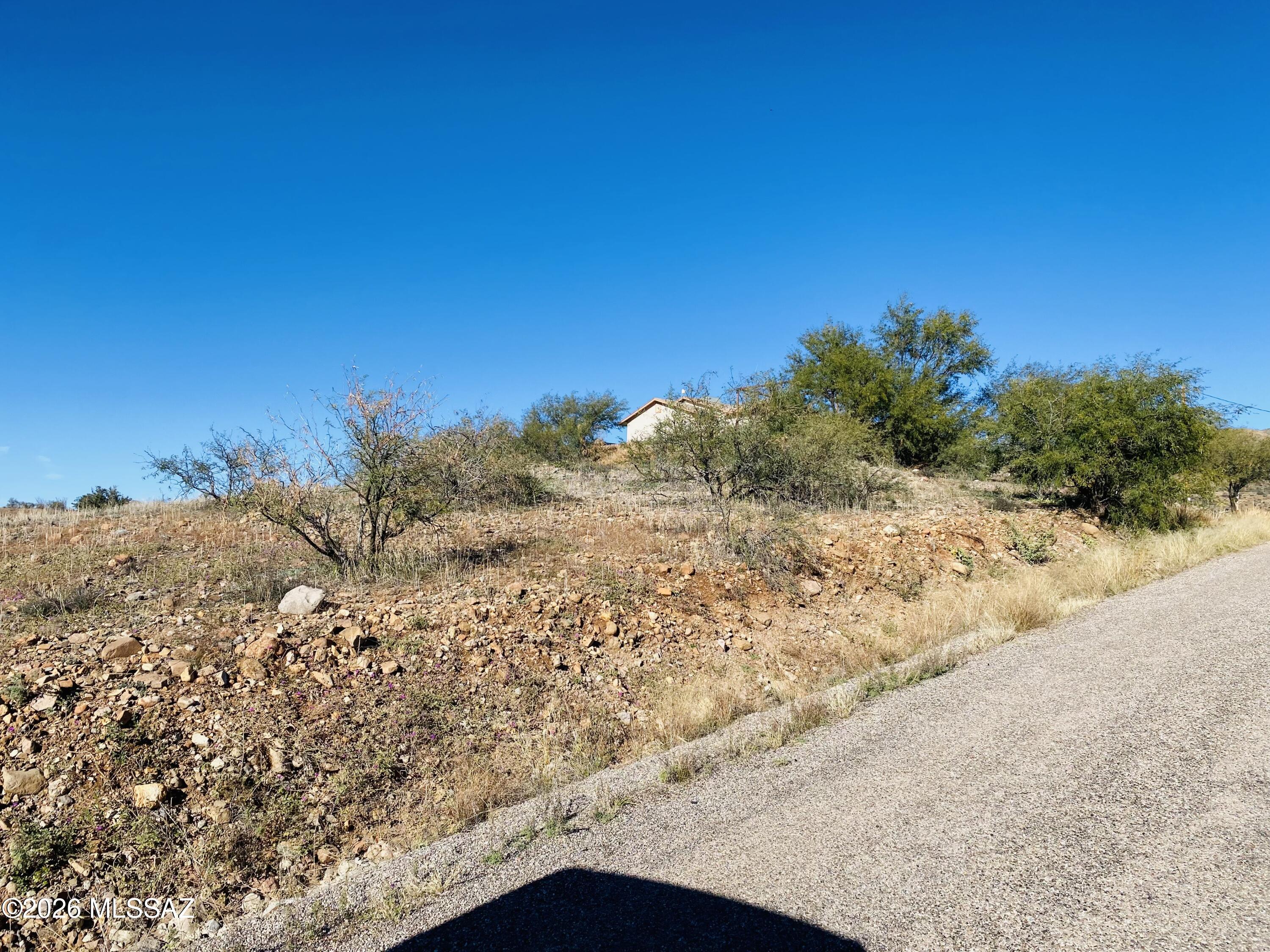 Enjoy breathtaking mountain views from this elevated homesite in beautiful East Rio Rico. Perched at a higher elevation, the property offers striking, close-up eastern views of Mt. San Cayetano and expansive vistas in nearly every direction. Conveniently located near I-19 Exits 17 and 25, as well as schools, shopping, and everyday amenities.

The lot is ready for your new home, with neighboring residences to the east and west providing a sense of community. Positioned approximately 4-5 feet above street level, the property captures sweeping, near 360-degree views--an ideal setting to build and enjoy the natural beauty of the area.