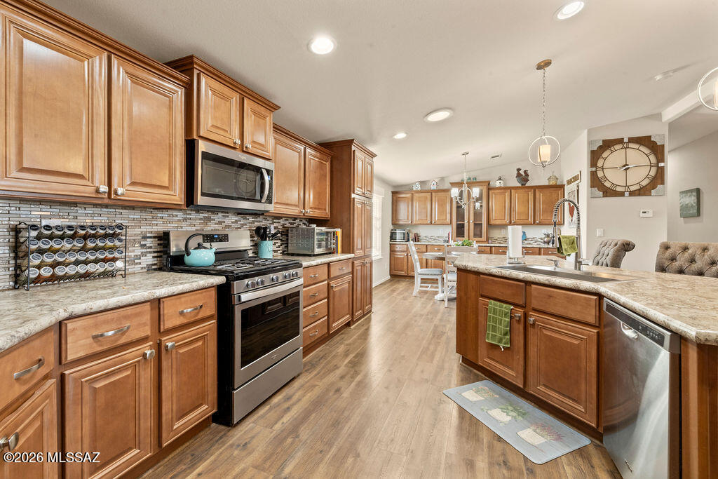 Come and enjoy life in the beautiful rolling hills of Benson. This incredible 1792 SQ Ft home with more storage than you can use, set with views of the area and beyond. Well, maintained 3 bedroom, two bath home with upgraded appliances, including washer and dryer. Large bedrooms, luxurious main bath with double sinks and breathtaking shower surround on 12.35 acres. 400 Amp electric box service.  Garage with workshop, cabinets, shelves and work-table. Raise planters with Fruit and vegetable drip Irrigation systems. Trees and other plants around the property make this your relaxing forever home. Two sheds and carport. This Cochise County RU-4 zoned parcel is perfect for your horses or other animals. Close to Benson for your shopping needs. Close to all Cochise County historic Sites. Sale includes Parcel 124-04-004K and Parcel 124-04-004L Don't miss out