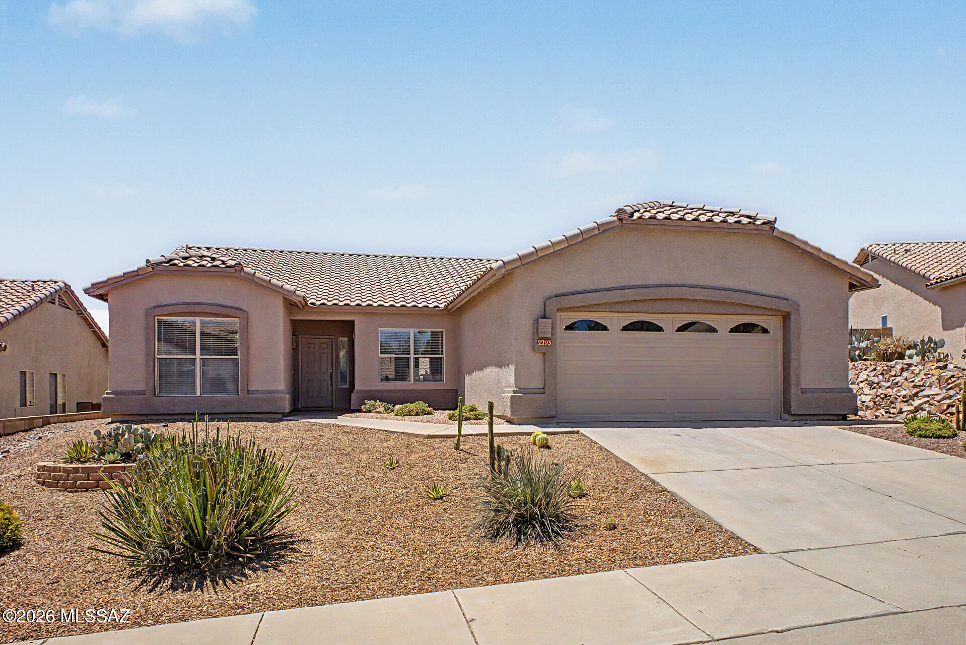 Beautifully maintained and exceptionally spacious, this stunning home in The Bluffs offers breathtaking Santa Catalina Mountain views and an ideal blend of comfort and style. Featuring 1,844 sq. ft. and OWNED solar, the home showcases soaring vaulted ceilings, elegant tile flooring, a bright open Great Room, and a versatile formal dining room perfect for entertaining or use as a home office. The inviting Great Room is filled with natural light and anchored by a cozy fireplace, while the open-concept kitchen boasts ample cabinetry, sleek stainless steel appliances, a breakfast bar, and sunny breakfast nook. The spacious primary suite features rich wood flooring, a charming bay window, and a luxurious en suite bath with dual vanities, updated shower, soaking tub, and oversized walk-in closet. Two additional guest bedrooms and a full guest bath provide privacy and convenience for family or visitors. Step outside to an expansive backyard retreat complete with a covered patio, extended paver seating area, built-in BBQ, outdoor fireplace with built-in seating, and stunning mountain views. Ideally located near a neighborhood park, schools, shopping, dining, medical facilities, The Loop river park access, and recreational amenities, this home truly has it all.