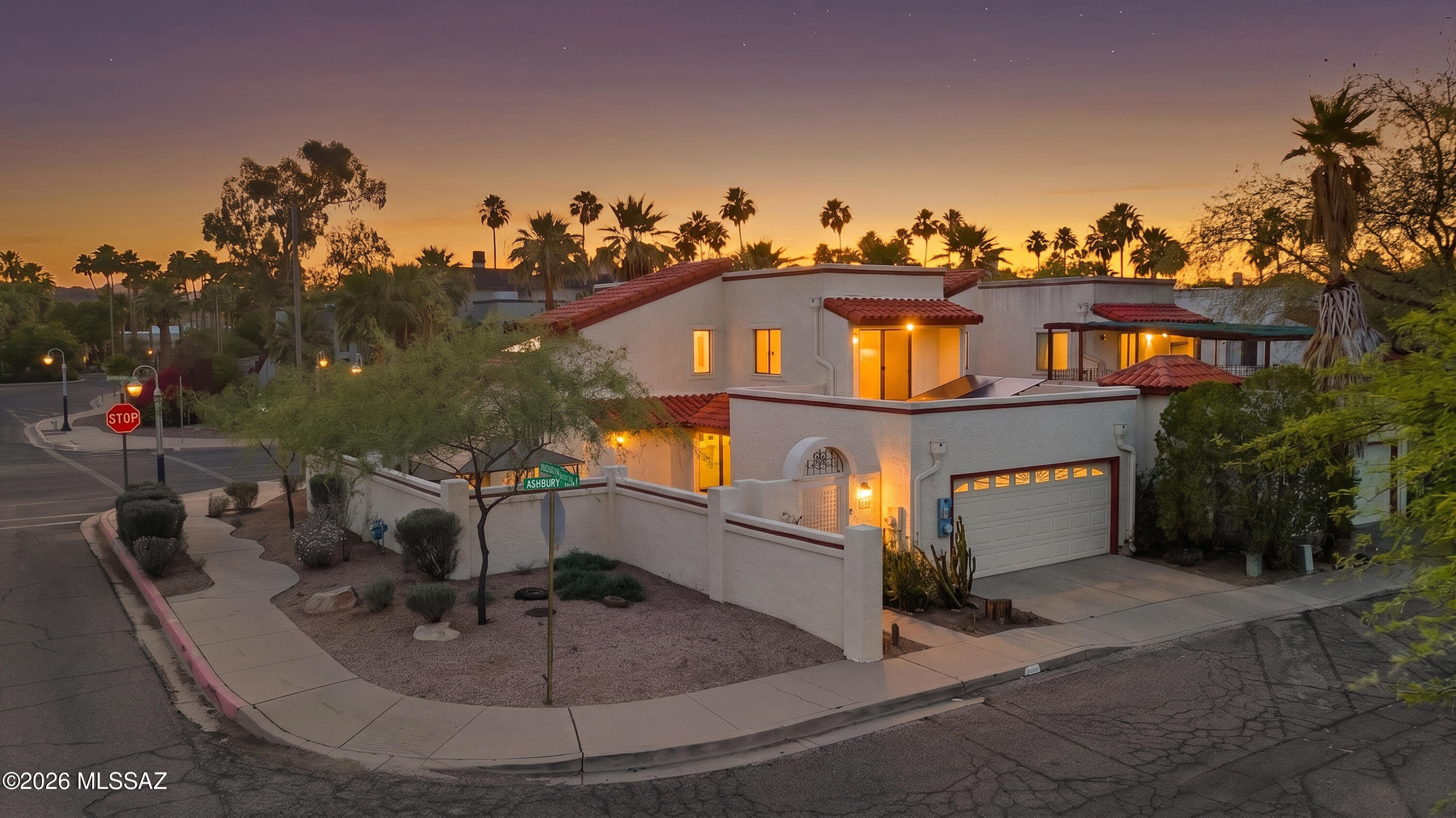 This attractive corner-unit DOWNTOWN townhome features no shared walls and includes a spacious yard AND a 2-car garage with an EV charging station! The home offers 3 bedrooms and 2 full baths, and is ideally located just 1 block from the Tucson Museum of Art. Recent upgrades include fresh interior & exterior paint, plus new carpet in bedrooms and stairs. Tucson Rolling Shutters are on several windows for privacy, security, and energy efficiency. The private, high-walled yard is perfect for entertaining and gatherings. Additional highlights include owned solar panels from TFS Solar. Vaulted ceilings make for an airy main living area and one bedroom and one full bathroom is located downstairs. Downtown living is calling you!
