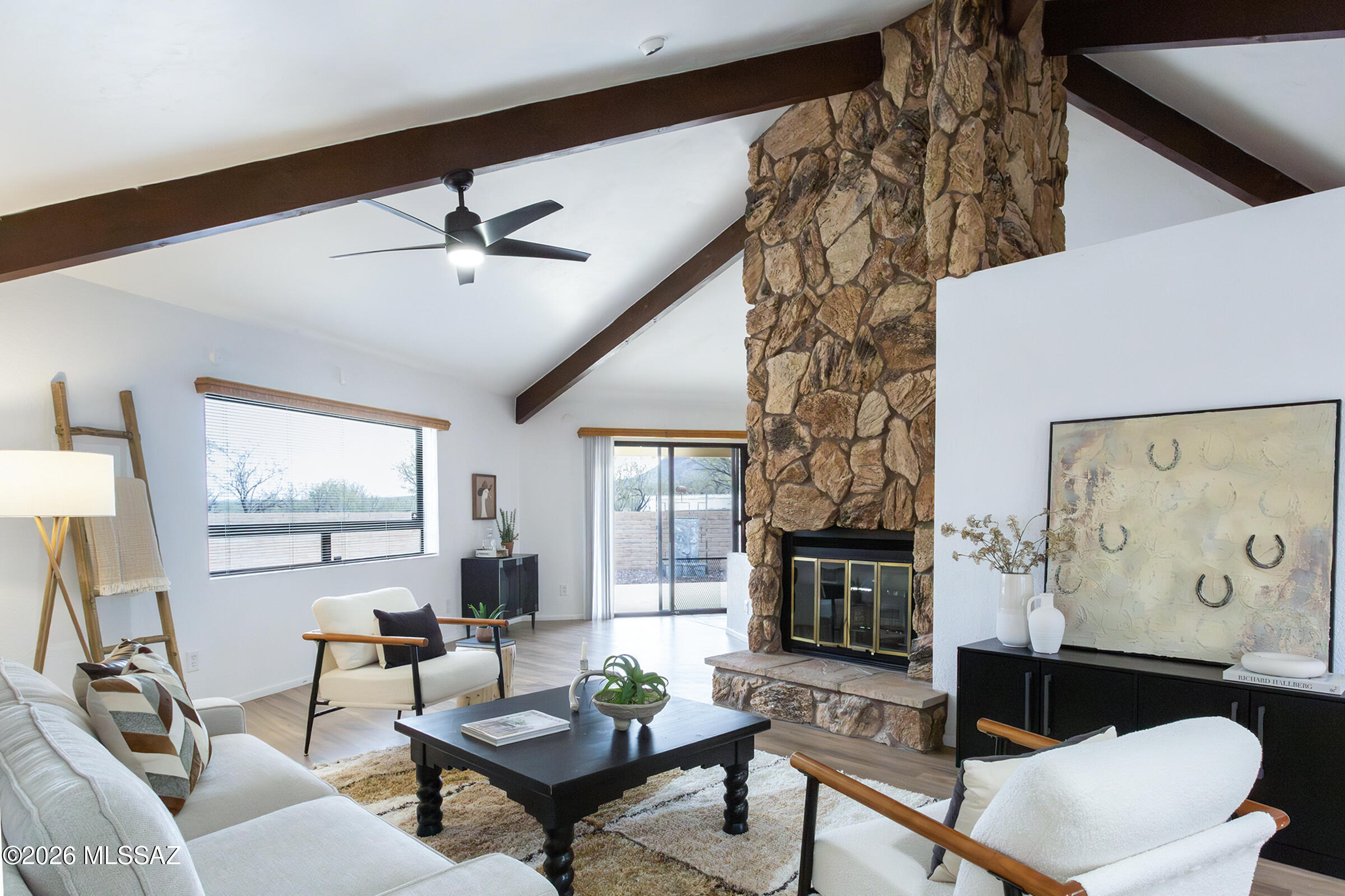 PRICE REDUCED!! Motivated seller, bring your offers! This one of a kind hexagonal home in Saddle Estates, Tubac, AZ is designed to capture stunning views that offers peace, privacy & plenty of room to roam. Nestled on 4.13 private acres, horse property, RV carport, storage sheds & more. Inside, enjoy wood & tile flooring, skylights, a workshop/den, covered patio & a sparkling pool. The open kitchen with a walk in pantry & breakfast bar flows into the great room, where a rock fireplace separates the dining & living areas. Step onto the wraparound porch to take in panoramic mountain views. Whether swimming, relaxing, or enjoying wildlife, this home is a peaceful retreat! Staging has been thoughtfully added to help you visualize the lifestyle this home offers.