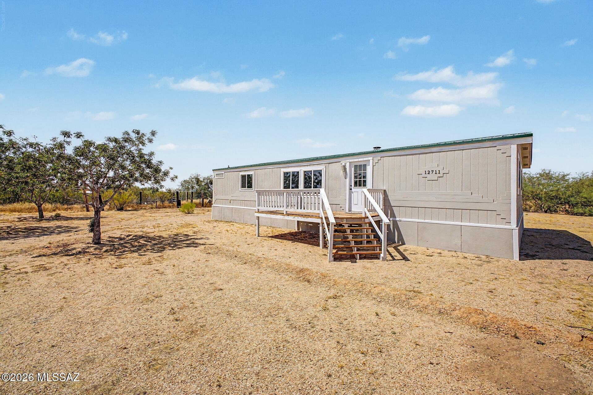 Great opportunity for affordable homeownership! Spacious manufactured home situated on a full acre in Marana. Features 3 bedrooms, 2 bathrooms, and a versatile bonus room ideal for a den or home office. Zoned for horses and perfect for those seeking a relaxed rural lifestyle. A must-see!