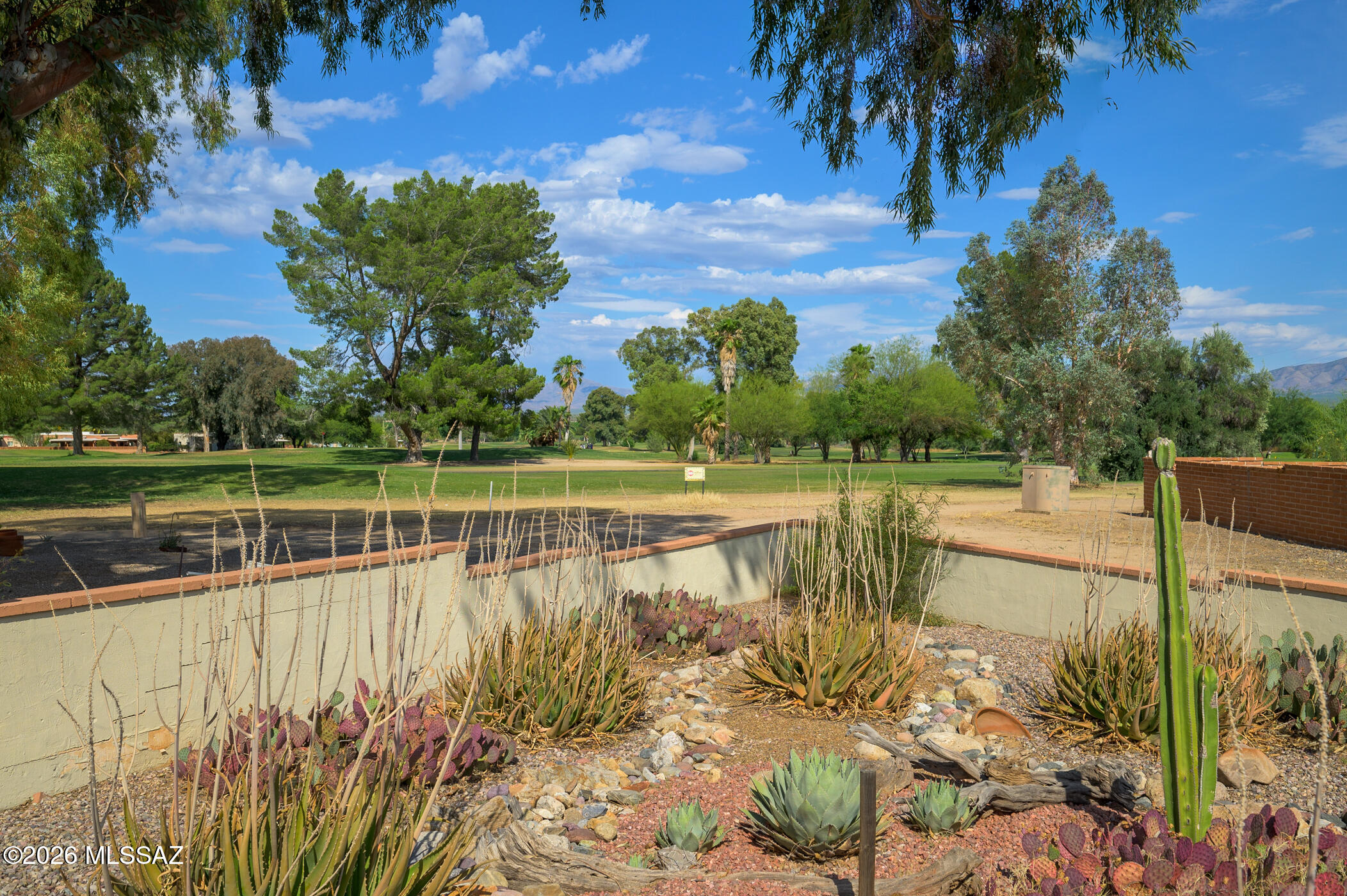 Welcome to premier living in the heart of the Arizona desert, where original Green Valley Southwest character meets modern comfort. Situated on a premium lot overlooking the Haven Golf Course and the Santa Rita Mountains, this home offers views from the kitchen, Arizona room, and back patio. Tucked away on a cul-de-sac, the property immediately stands out with tasteful desert landscaping and a charming arched front patio. Inside, you're welcomed by a spacious living room featuring a beige tile flooring that flows seamlessly throughout the home, enhancing its warm Southwest feel. This wonderfully updated home can also be purchased FURNISHED, making it truly move-in ready and checking all the boxes on your wish list. The kitchen offers a clean, timeless design with white cabinetry, laminate countertops, and sleek black appliances. Both bedrooms are generously sized with versatile layouts. The primary suite features additional built-in cabinetry for extra storage and a beautifully custom-tiled walk-in shower. Step outside to your private backyard retreat. The fenced, desert-landscaped yard is a true oasis, complete with mature landscaping and plenty of space for morning coffee, outdoor dining, or relaxing evenings under the Arizona sky. The low-maintenance setting also provides room for future customization or expansion. Additional highlights include a dedicated indoor laundry room and a 1-car carport for added convenience. The property also boasts an incredibly low HOA fee of just $60 per year. Located minutes from Green Valley Recreation East Center, you'll enjoy access to pools, fitness facilities, classes, and community events. With convenient access to I-19, Tucson, and the artistic charm of Tubac, this home offers the perfect blend of peace, privacy, and connection to everything Southern Arizona has to offer.
