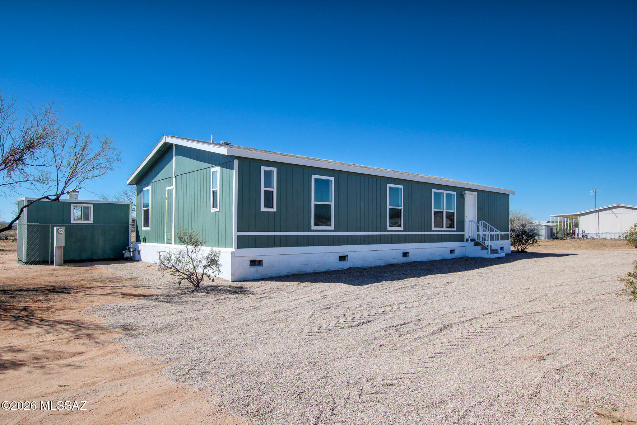 Like-new, fully remodeled manufactured home situated on just over an acre in the desirable Marana/Avra Valley area. This 3-bedroom, 2-bath home features a fresh, modern interior with quality updates throughout, offering a move-in-ready opportunity. The spacious lot provides plenty of room for horses, animals, RVs, or future improvements. Enjoy peaceful desert living with wide-open views while still benefiting from convenient access to I-10, shopping, and nearby amenities. No HOA and endless possibilities for those seeking space, privacy, and flexibility.