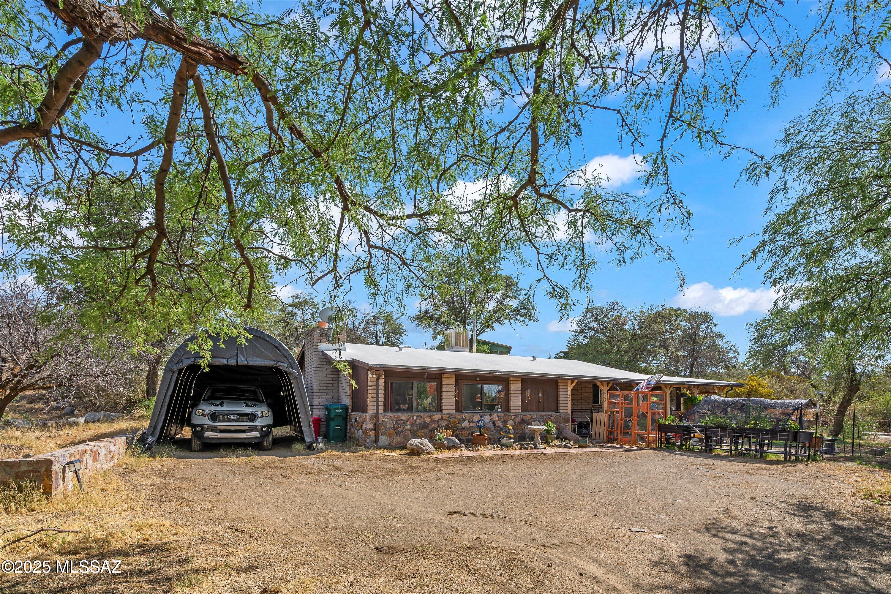 Photos have been virtually decluttered for tenant privacy. Discover the charm of Oracle living in this delightful block ranch-style home! Boasting 1,320 sq ft of comfortable living space, this 2-bedroom, 2-bath residence offers a perfect blend of cozy and spacious. Step into a generous living room featuring a warm, inviting fireplace — ideal for cool mountain evenings. The sun-drenched foyer is perfect for reading or quiet relaxation. Enjoy meals in the open dining area adjacent to a large, functional kitchen. The expansive screened Arizona room is perfect for enjoying the fresh mountain air year-round, while the spacious front porch offers a welcoming spot to unwind.