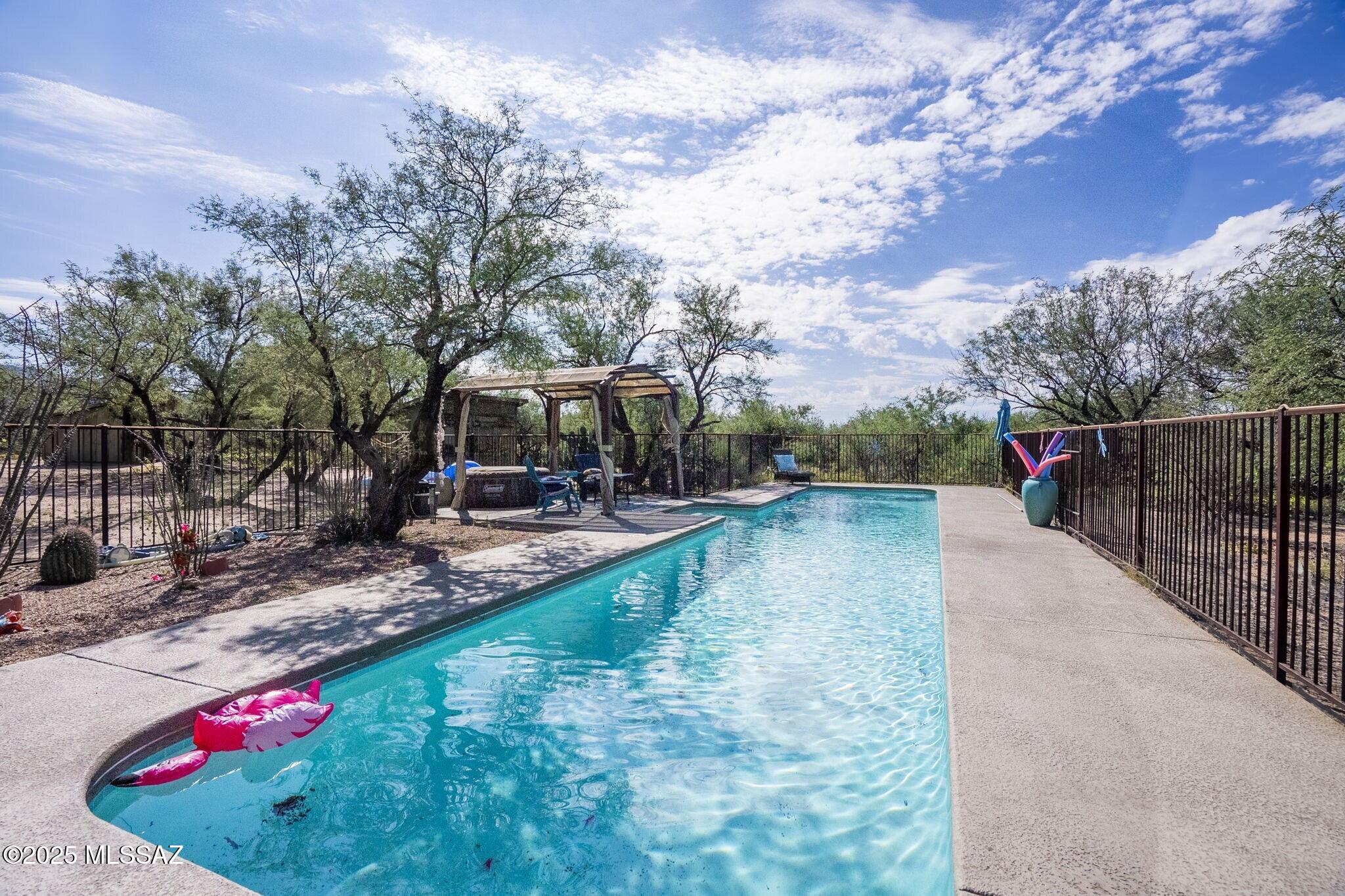 TWO HOMES SET ON APPROXIMATELY 10 ACRES in desirable Elephant Head, this rare dual-residence ranch offers space, privacy & endless possibilities. With two separate homes on the property, it's ideal for multi-generational living, guest retreat or rental income potential, surrounded by wide-open desert & panoramic mountain vistas. Designed for horse lovers, the property features a well-appointed tack room, hay barn, arena & multiple stalls, for turnkey equestrian life. After a long ride under the sun, cool off in the sparkling pool while the mountains fade to blue in the distance. Both homes have been thoughtfully positioned to capture the scenery & preserve a sense of independence. Whether you're looking for a working ranch,private compound, or peaceful desert escape, this property delivers