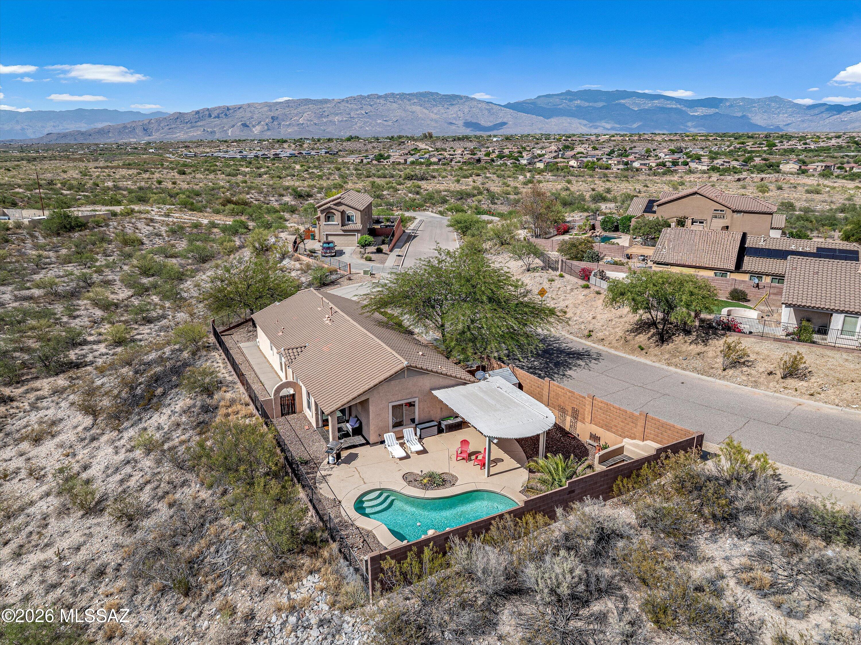 Situated on a rare ''island'' lot in the beautiful Rancho del Lago community! This 3 bedroom/2 bath home features an open concept, split floorplan, including a den and all tile floors. The extra-long driveway invites you into this private dwelling. Outdoor living is ready poolside with a built-in BBQ, beehive fireplace with hardscape seating, and view fencing to enjoy this desert oasis. Vail schools & close proximity to I-10, Raytheon, Davis-Monthan and more!