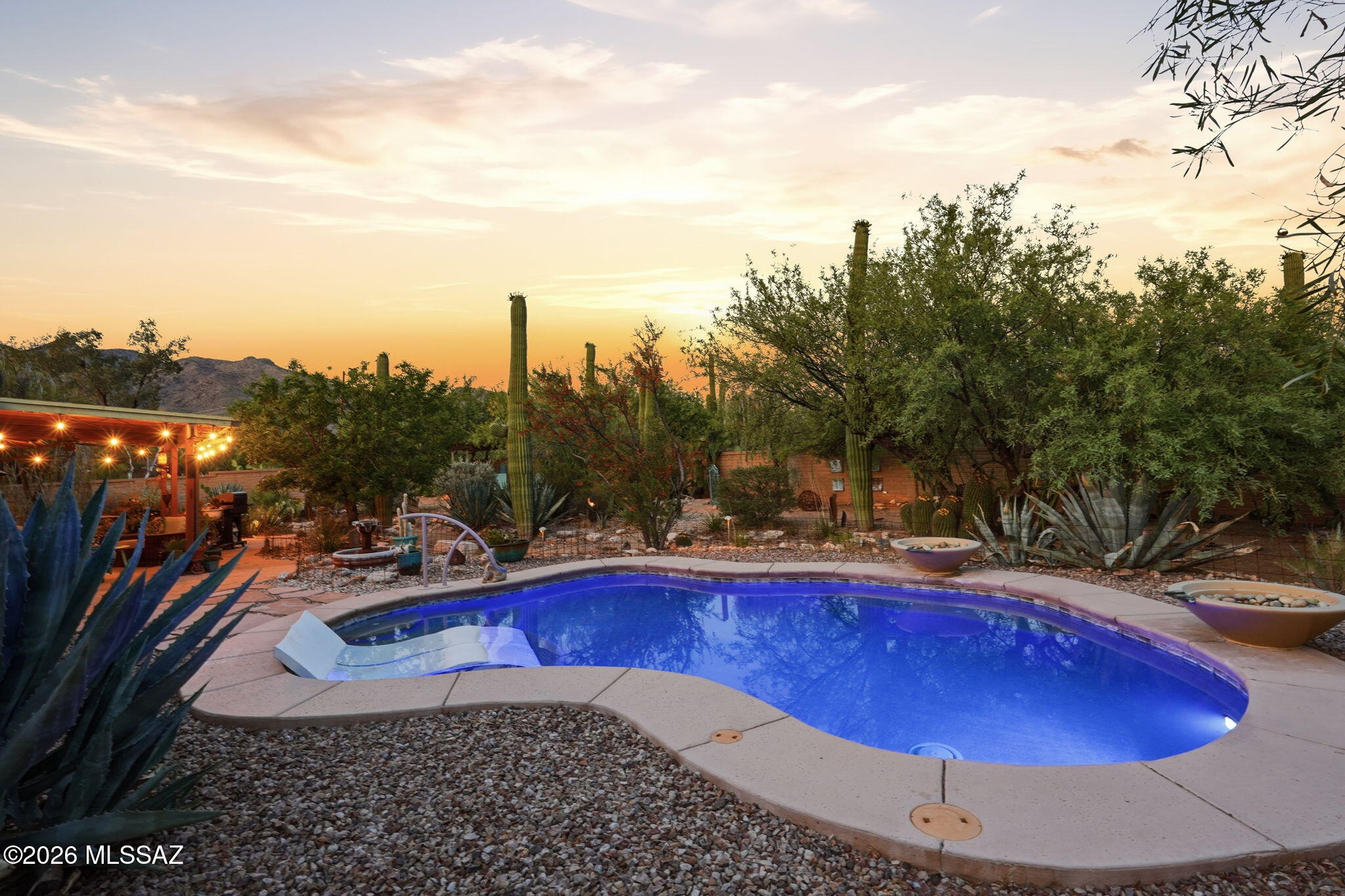 Nestled on a quiet, saguaro studded corner lot is this beautifully maintained home with mountain views from the front and back.  Updated kitchen and baths blend style and functionality. 3BR/2BA floor plan offers formal dining,  family room off the kitchen, and separate living room. Plantation shutters & ceiling fans thru-out. Step outside to a fully enclosed backyard retreat featuring a charming covered patio, ramada, beach-entry pool with seating and water feature, plus ample space for pets and gardening. Designed for both relaxation and entertaining, exceptional outdoor living area offers complete privacy, mature vegetation, and spectacular sunsets. NO carpet, NO HOA and OWNED solar provide added value and efficiency. Pre-listing home inspection is available for added buyer confidence.