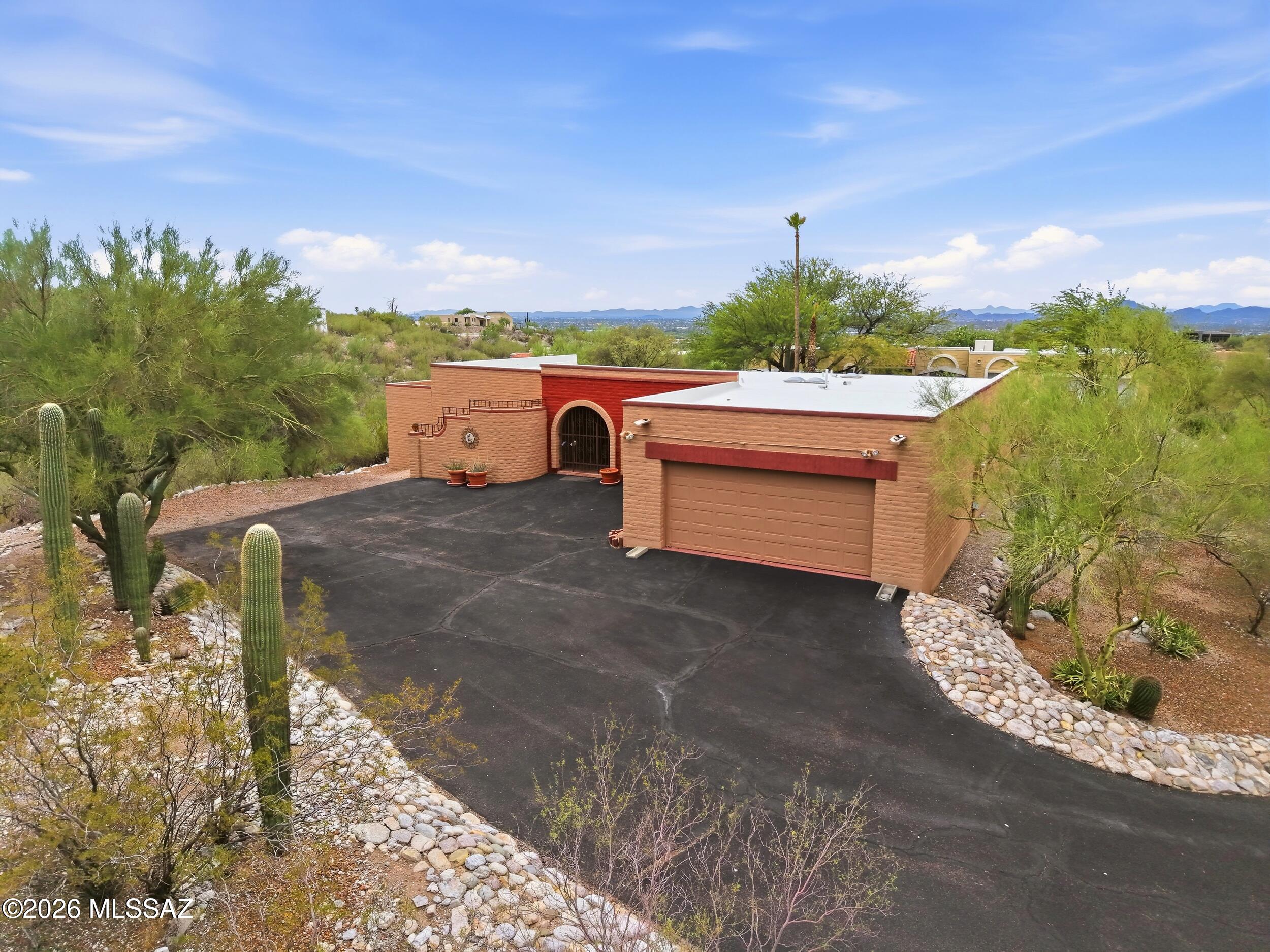 Welcome Home to the Top of the Hill in Sunrise Presidio Village. This 3 bedroom, 2 bathroom territorial home features architectural elements that are reflective of the Southwest region's history. The home is perched high up in the foothills with sweeping mountain and desert landscape views that can be enjoyed from both inside the home or out by the freshly replastered pool. Step inside to the warmth of authentic saltillo tiles, thick premium carpet, warm custom paint, exposed wood beams and more. The kitchen is updated with full overlay wood cabinetry, stainless steel appliances and a glass tile backsplash. The owner's suite is spacious, boasts an en-suite bathroom with a dual vanity and Roman style shower with dual showerheads. Enjoy this well-maintained home. Come. See. Stay!