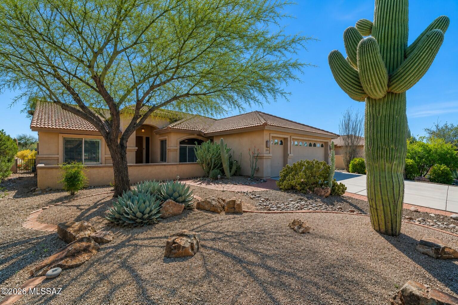Experience the beauty of desert living in this exceptional Exp Laredo model backs to untouched natural open space. Breathtaking mountain views and abundant wildlife create a truly serene setting. The peaceful backyard is perfect for relaxing or entertaining and patio that invites you to soak in the stunning surroundings. Inside has been thoughtfully updated with a new kitchen, bathrooms, and laundry room cabinets and quartz countertops. Wood plank ceramic tile flooring flows seamlessly throughout. The Great Room is highlighted by a sleek accent wall with integrated lighting. Front bricked patio is shaded by a mature mesquite tree, complemented by a majestic saguaro cactus that enhances the home's authentic SW character. 2-car garage plus golf cart garage & storage cabinets. Reroofed 2020.