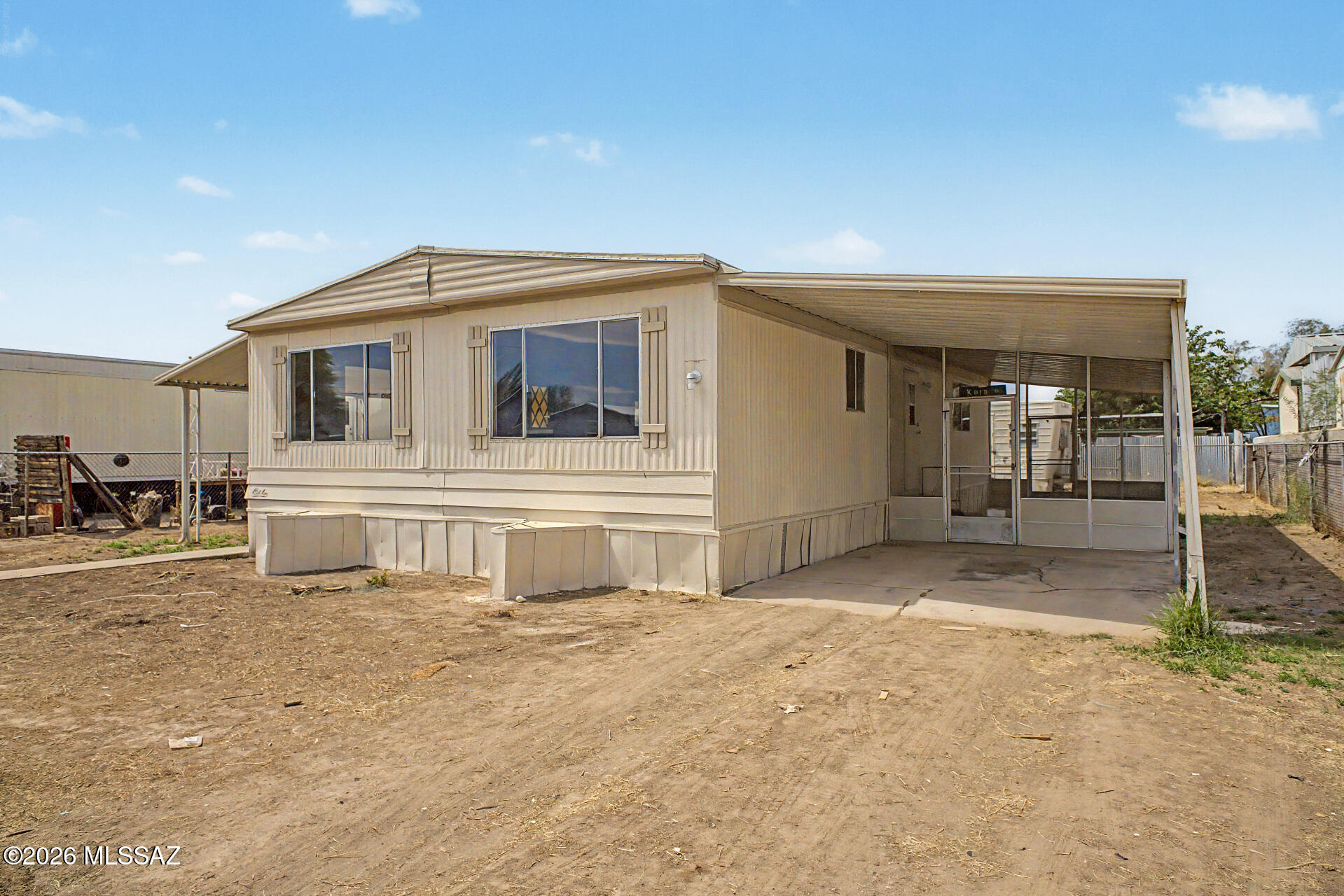 Charming 2-bedroom, 2-bath manufactured home offering 1,152 sq ft of comfortable living space on a 6,011 sq ft lot with no HOA. Features include a family room, breakfast bar, gas range, laminate countertops, laundry closet, and a covered/enclosed patio -- perfect for outdoor enjoyment. Forced air heating and natural gas utilities. Brand new central A/C unit to be installed prior to closing with an accepted offer. One covered carport space. The mobile home in the back conveys as-is -- it has utilities connected and can remain or be removed at buyer's discretion. Vacant and easy to show. Owner/Agent.