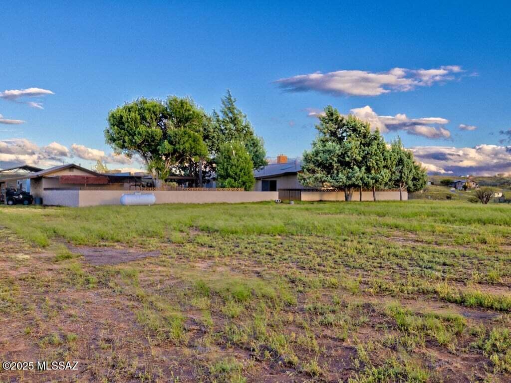 Well built masonry home, guest home and shop sits on a double lot allowing large mountain / open space views. The home is surrounded by a block patio wall with mature trees and large outside living space, includes a wine/root cellar in the courtyard. Property Northern border is Bobacomari Ranch. Front of the home features a pond which could be further developed. This Ranch style home has great bones and huge potential. Live in main house and rent guest home or even the other way around. Enjoy the warmth in our cool months with the double sided wood fireplace insert. Internet tax rates are showing incorrectly 2024 Tax $2508.30