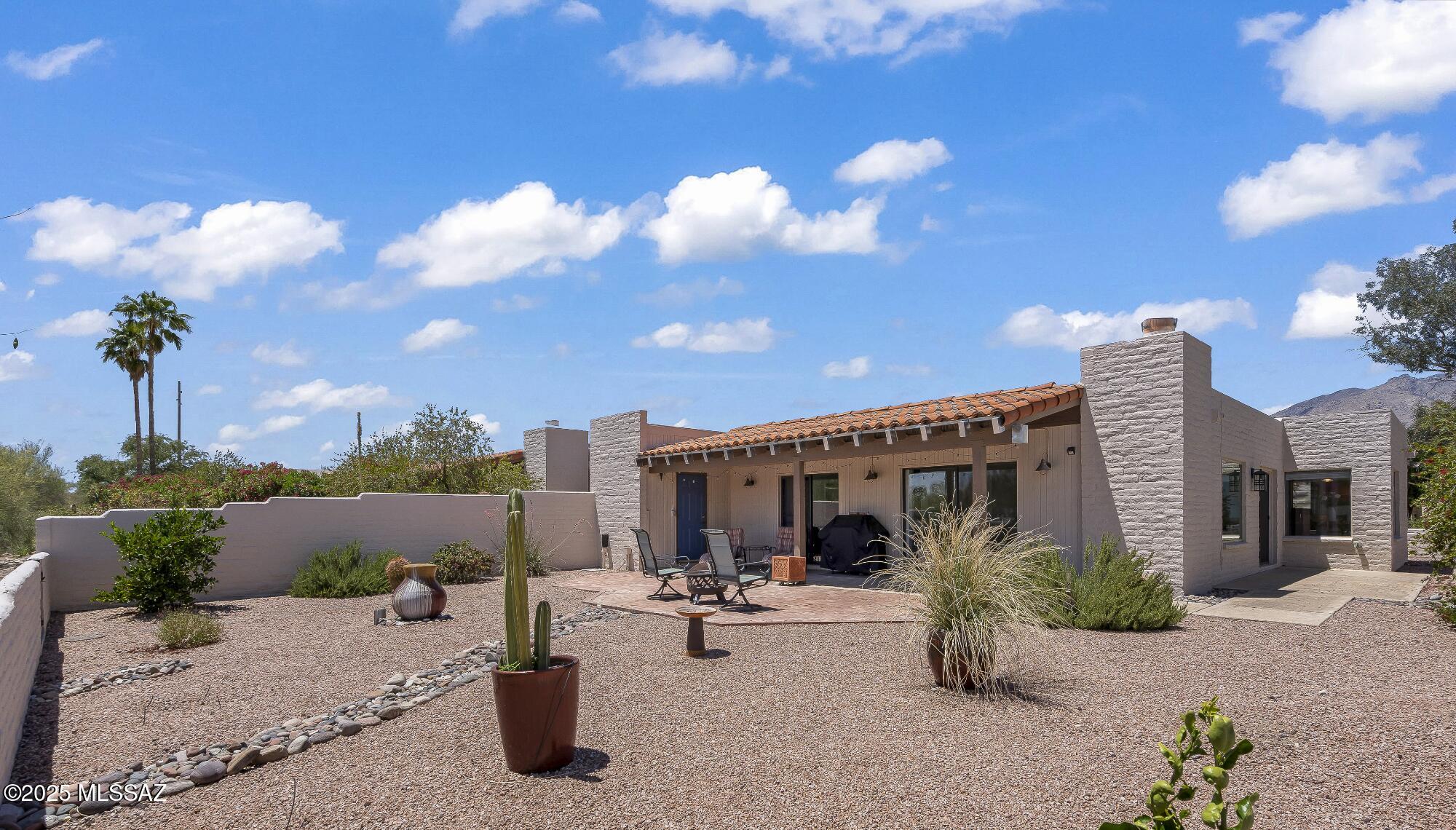 Welcome to your new winter retreat or year round abode. Attractive entry courtyard. In a small quiet enclave of lower foothill homes, sits this well maintained 1627 square ft townhome. 2BR 2BA, large laundry room could be office space Bright breakfast rm off kitchen w/mtn and city views. Updated kitchen has quality cabinets, quartz counters, ss appliances and opens to great rm with fireplace. Great rm opens to both rear and side patios. Bathrooms completely updated. Tile floors everywhere except carpeted bedrooms. Newer heat pump,  window coverings, upgraded electric panel. Charcoal filtered water system Attractive simplistic landscaping with large potted plants and fountain. One of the most desired and best lots in subdivision offering complete privacy, overlooking common ar area and desert. Easy access to U of A, superb restaurants, hiking trails and shopping. Community pool. Semi annual assessment of $1117.25 includes HOA fee, Rural Metro subscription, Refuse collection and Common area insurance