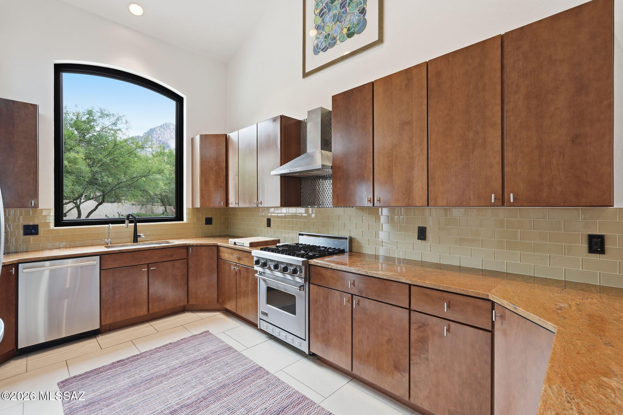 Welcome to your private desert sanctuary in the exclusive guard gated community of La Reserve! Perfectly positioned against the rugged, majestic backdrop of Pusch Ridge, this meticulously maintained 3BD/2BA (2,595 sqft) residence offers the ultimate blend of sophisticated living and the raw, natural beauty of the Sonoran Desert. Step inside to a light-filled interior where soaring ceilings and large picture windows bring the outdoors in. This home features all brand-new energy efficient windows from Renewal by Anderson, totaling $40k. The expansive floor plan is designed for both grand entertaining and quiet comfort, featuring a welcoming Great Room. The gourmet kitchen is a chef's delight, boasting ample cabinetry and a thoughtful layout that flows effortlessly into the casual dining and and living areas. The primary suite serves as a tranquil retreat, offering a spacious layout, walk-in closet, and a spa-like bath for the ultimate relaxation. Two additional generously sized guest bedrooms provide plenty of room for family, visitors, or a dedicated home office to take advantage of the quiet, gated surroundings. Outdoor living is a true highlight here. Relax on the covered rear patio and enjoy the peaceful silence of the desert, with the towering peaks of the Santa Catalina Mountains as your constant companion. Close to the Coronado National Forest, you are just minutes away from the hiking trails of Catalina State Park and the premium dining and shopping of the Oro Valley Marketplace. With a garage that has ample storage space (with a brand-new door) and move-in ready appeal, this home is your gateway to the premier Oro Valley lifestyle!