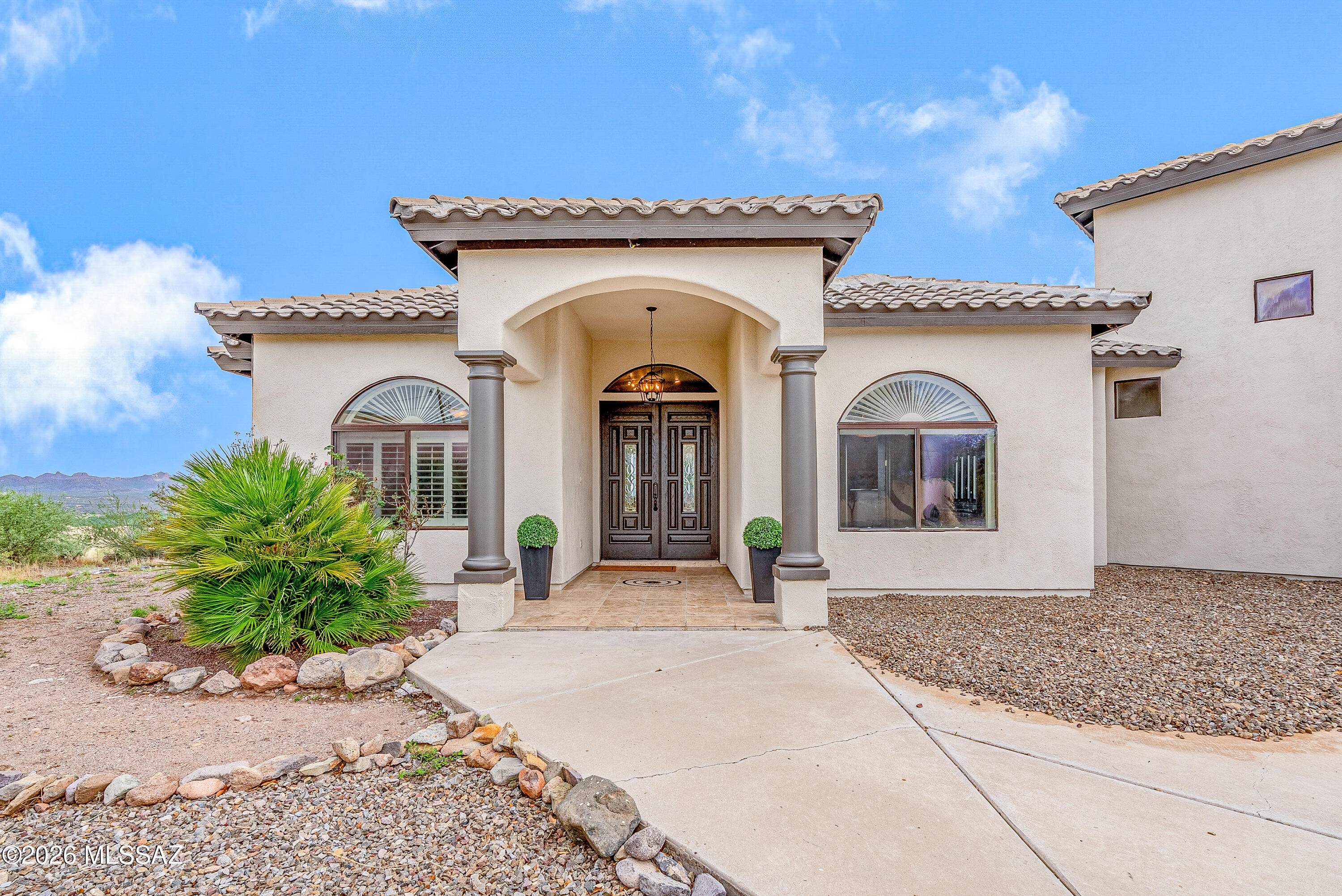 She's BACK & better than ever! A rare combination of land, views, flexibility & value all within a sought-after gated setting. 1.79 acres, sweeping views of the Santa Rita Mountains. This thoughtfully designed home offers spacious indoor/outdoor living with vaulted ceilings, tile flooring & custom finishes throughout. The kitchen features granite countertops & backsplash, stainless steel appliances, oversized passthrough, & a bright adjoining dining area. Main-level flex space is perfect for an office, den, media room, or guest room. Upstairs, the primary suite includes a private balcony-the views!!! dedicated office nook & spa-style bath w/dual sinks, jetted tub & separate shower. Enjoy covered patio plus a triple-bay garage & additional parking pad for RV or boat.