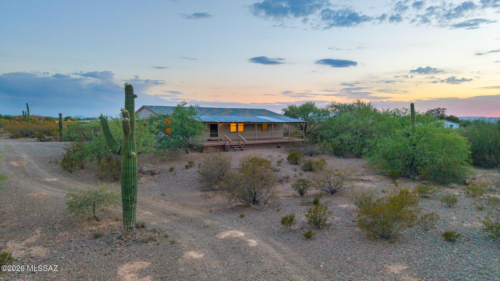 Escape to your own private desert retreat on 4.17 Acres surrounded by majestic saguaros, native vegetation, and breathtaking sunsets. Step inside to discover a bright, open split floor plan with vaulted ceilings, walk-in closets, fresh interior paint, and brand-new carpeting and luxury plank vinyl throughout. Expansive living and dining areas flow seamlessly into the spacious kitchen with oak cabinetry. There is the oversized covered front porch stretching across the home--an ideal place to enjoy morning coffee, evening sunsets, and the tranquility of the surrounding desert landscape. Award Winning Vail School District. Also includes separate 16' X 24' building (No Permits Found) Possible Guest House? Studio? Workshop? Horses allowed with plenty of usable land.