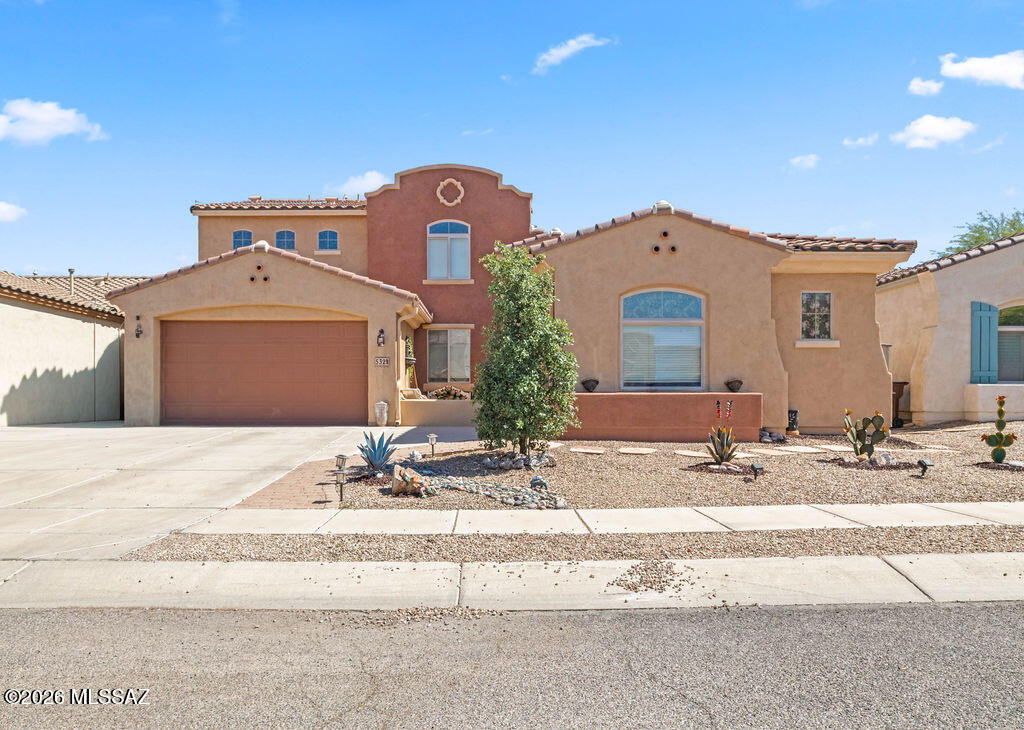 532 E Via Puente De Las Rosas offers flexible two-story living in the Rancho Sahuarita community. The layout includes a downstairs primary suite, den/office, three upstairs bedrooms, and a loft overlooking the kitchen and great room. Granite counters, stainless steel appliances, tile in main areas, and fresh interior paint add everyday appeal. Paid-off solar helps support lower energy costs. Enjoy a 7,187 sq ft lot and access to community amenities including Club Rancho Sahuarita, pools, parks, lake, trails, and fitness options. Near Fry's Marketplace, Starbucks, Anza Trail School, and Walden Grove High School.