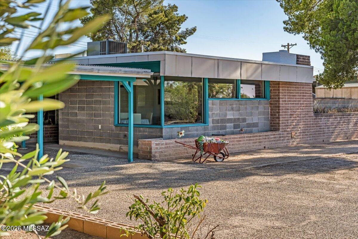 Incredible opportunity to call this unique mid-century cement block home in Carlos Terrace yours! Offering timeless character, generous living space, dual-pane windows, a new main water line in 2025, HVAC replaced in 2025 & Evap Cooler replaced in 2024. Spanning a generous 2,332sqft, this 1950s Prairie-Style, 3bed, 2bath home features both a spacious living room and a separate family room flooded with natural light and stunning mountain views. Step outside to one of two completely enclosed oversized yards, creating the perfect setting for outdoor dining, relaxing, gardening, or hosting! Placed on a quiet cul-de-sac, this home is convenient to local restaurants, TMC Hospital, the Rillito River Bike Path, Fort Lowell Park, the University of Arizona and Davis Monthan AFB.