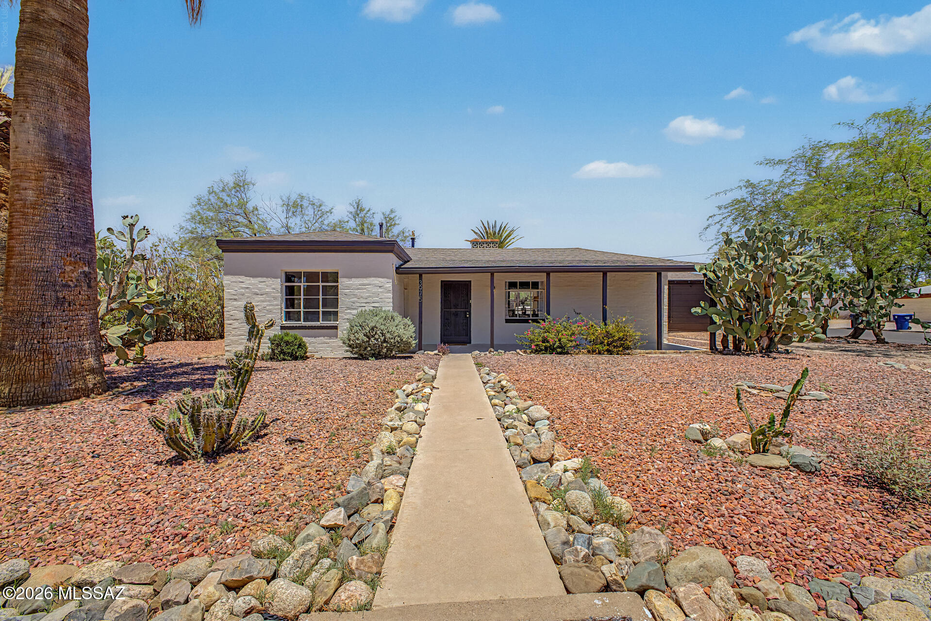 Charming Arizona home featuring 2 bedrooms and 1 bathroom with a cozy fireplace as the centerpiece of the living room. Situated on a spacious lot with stunning mountain views, this property offers a large backyard with mature desert landscaping and plenty of room to enjoy outdoor living. The property also presents potential for an ADU conversion, creating opportunities for additional living space, a guest house, or rental income. A wonderful blend of character, functionality, and desert beauty.