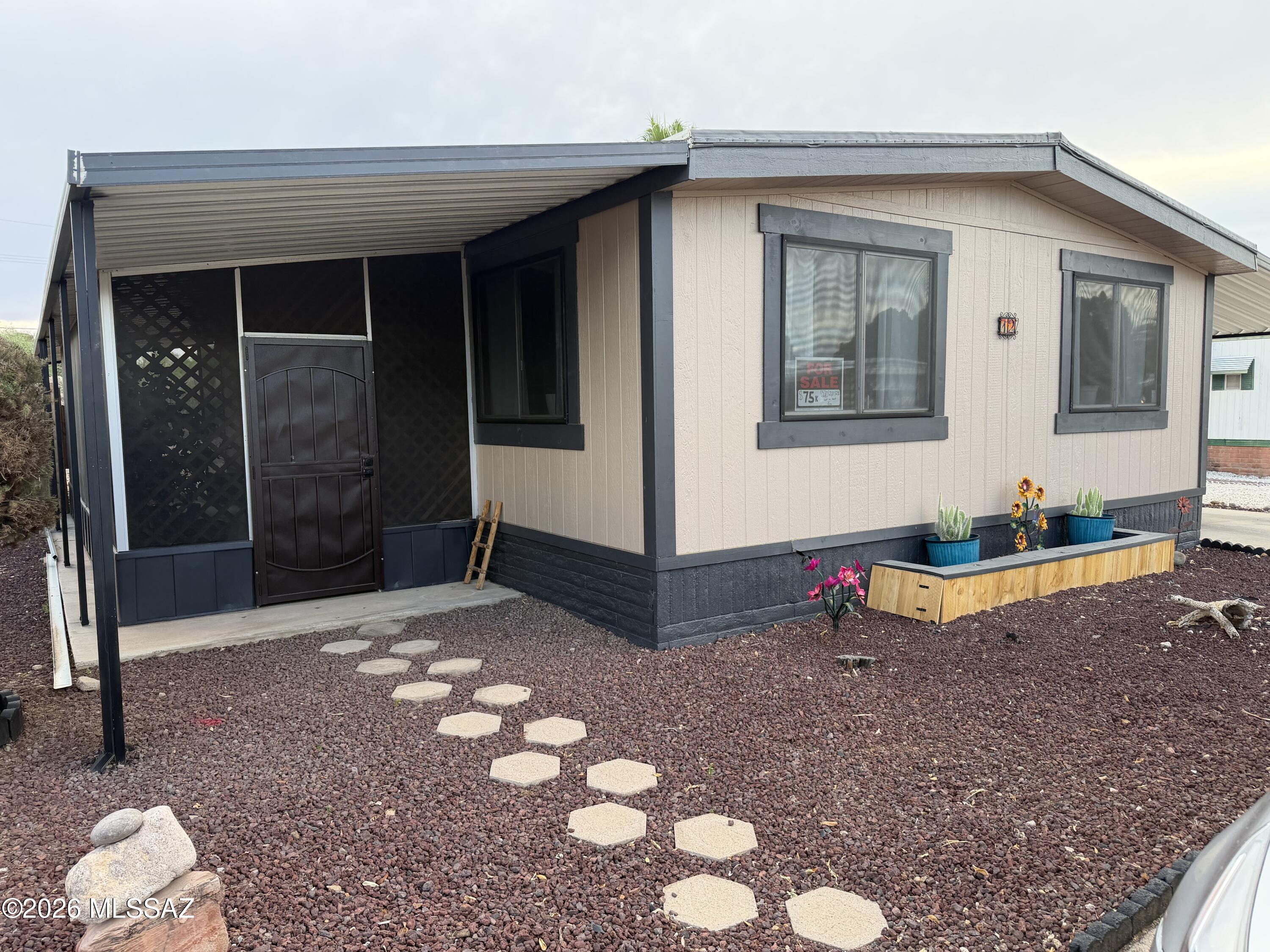 This charming 2-bedroom, 2-bath home is in a friendly 55+ community.  Enjoy peace of mind with a new A/C.  The spacious interior has a comfortable layout.  The yard has a 6-foot-tall cedar fenced backyard providing privacy and it is a great area for any four-legged family pet.  A screened-in patio adds ideal outdoor living space.  With updated touches throughout and desert landscaping for easy maintenance, this home is move-in ready just for you.  The park has heated pool, spa, fitness center and so much more.  Land Lease is approximately $750 per month.