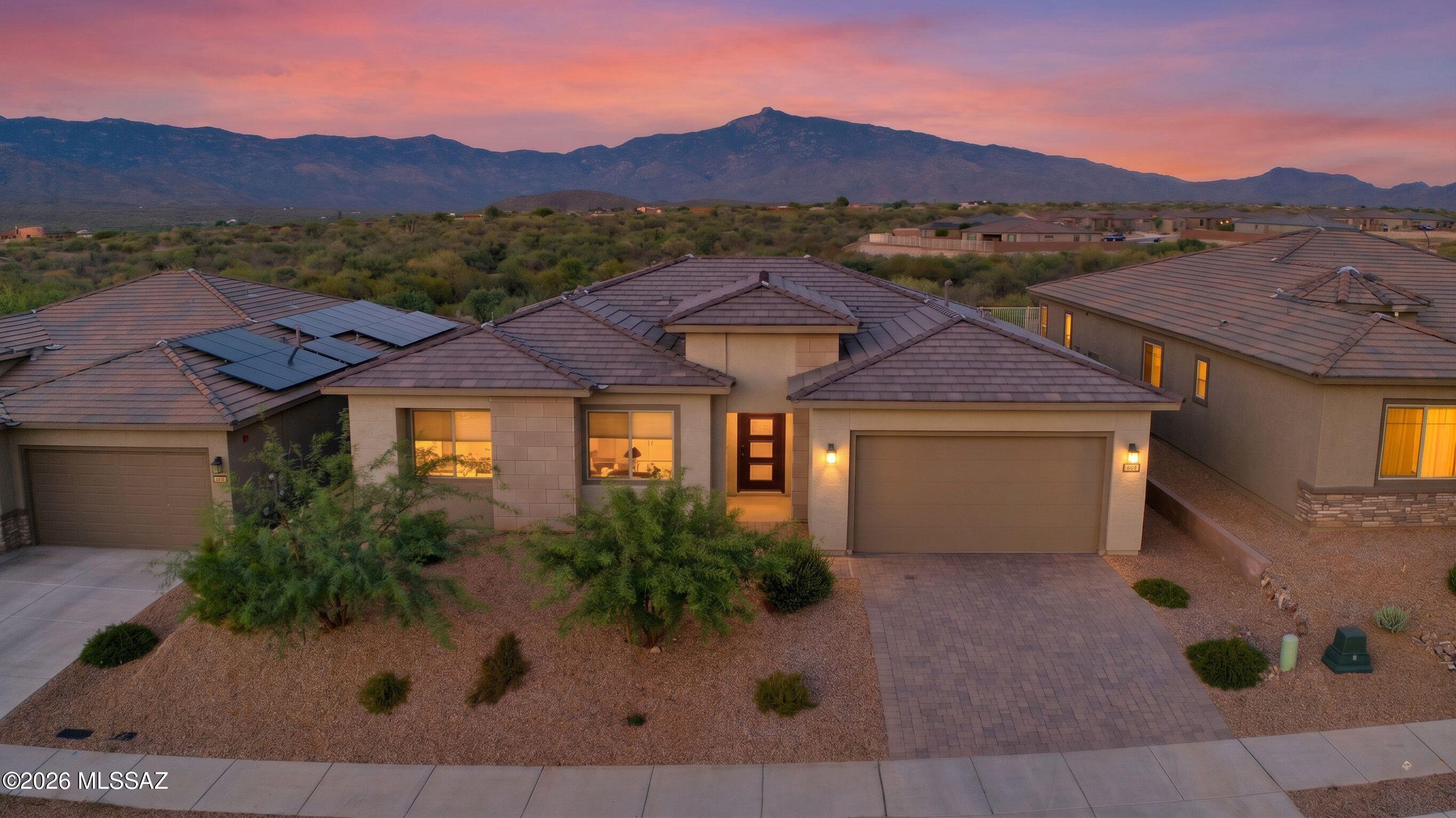 Welcome to Del Webb at Rancho Del Lago! Located in the Rincon Valley, this premium lot has unobstructed mountain views with natural desert behind (owned by HOA, cannot be built). With a northeastern backyard, enjoy sunny mornings and shady evenings as you enjoy the splendor of the Rincon Mountains. This well appointed Pursuit floorplan includes the luxury walk in shower option in the primary and the lighted, built in entertainment center with TV wall for 85'' TV. With the 4 panel slider, your patio becomes part of your living and entertaining space as you enjoy the amazing mountain views. The new clubhouse was just opened featuring pickleball, bocce ball, resort style pool & spa, fitness facilities, billiards, card room, ball room and lots of clubs and activities. Come see it in person!